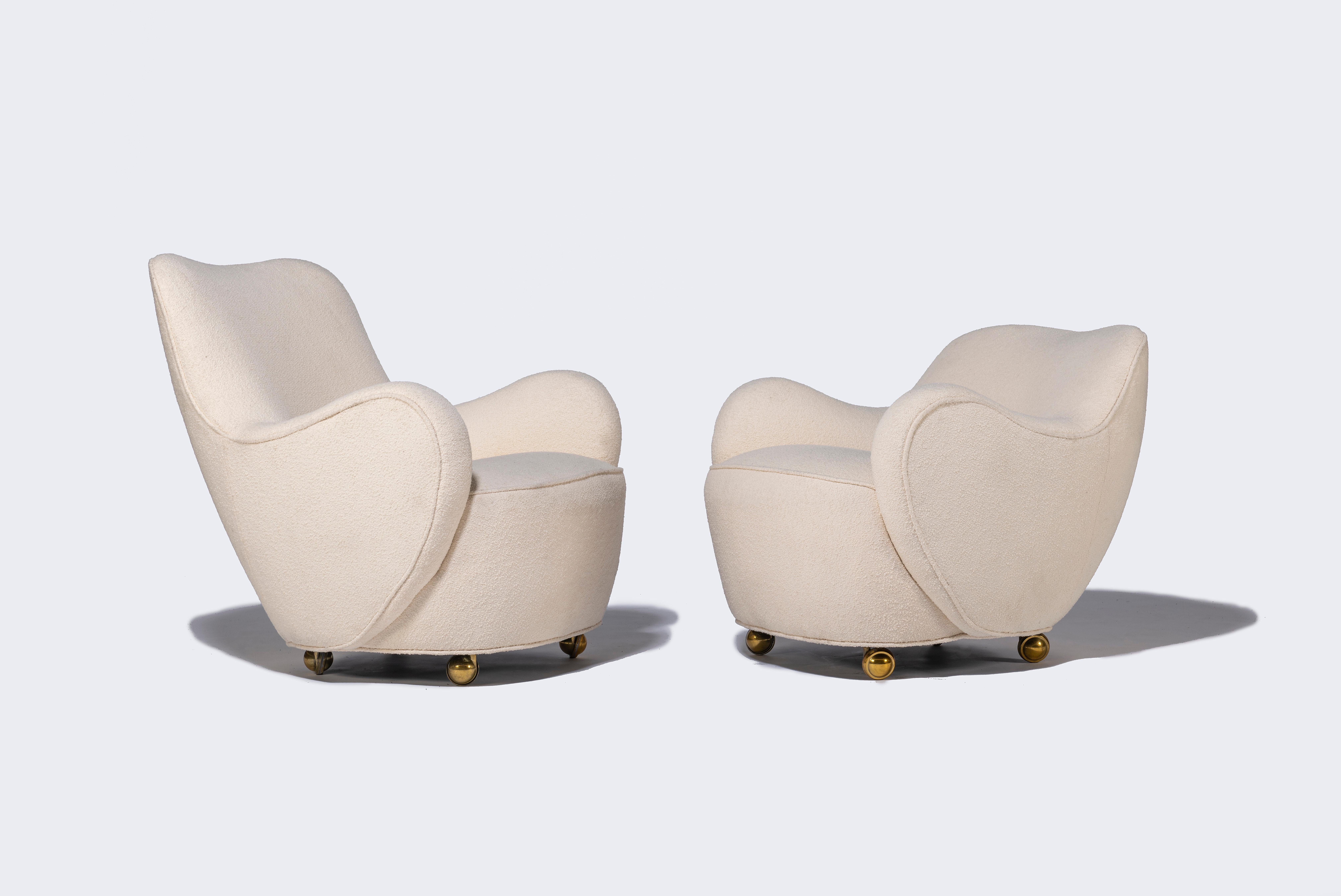 A rare pair early high and low backed fireside lounge chairs by Vladimir Kagan. Newly reupholstered.

Dimensions below are for high backed chair.

Low backed chair: 25