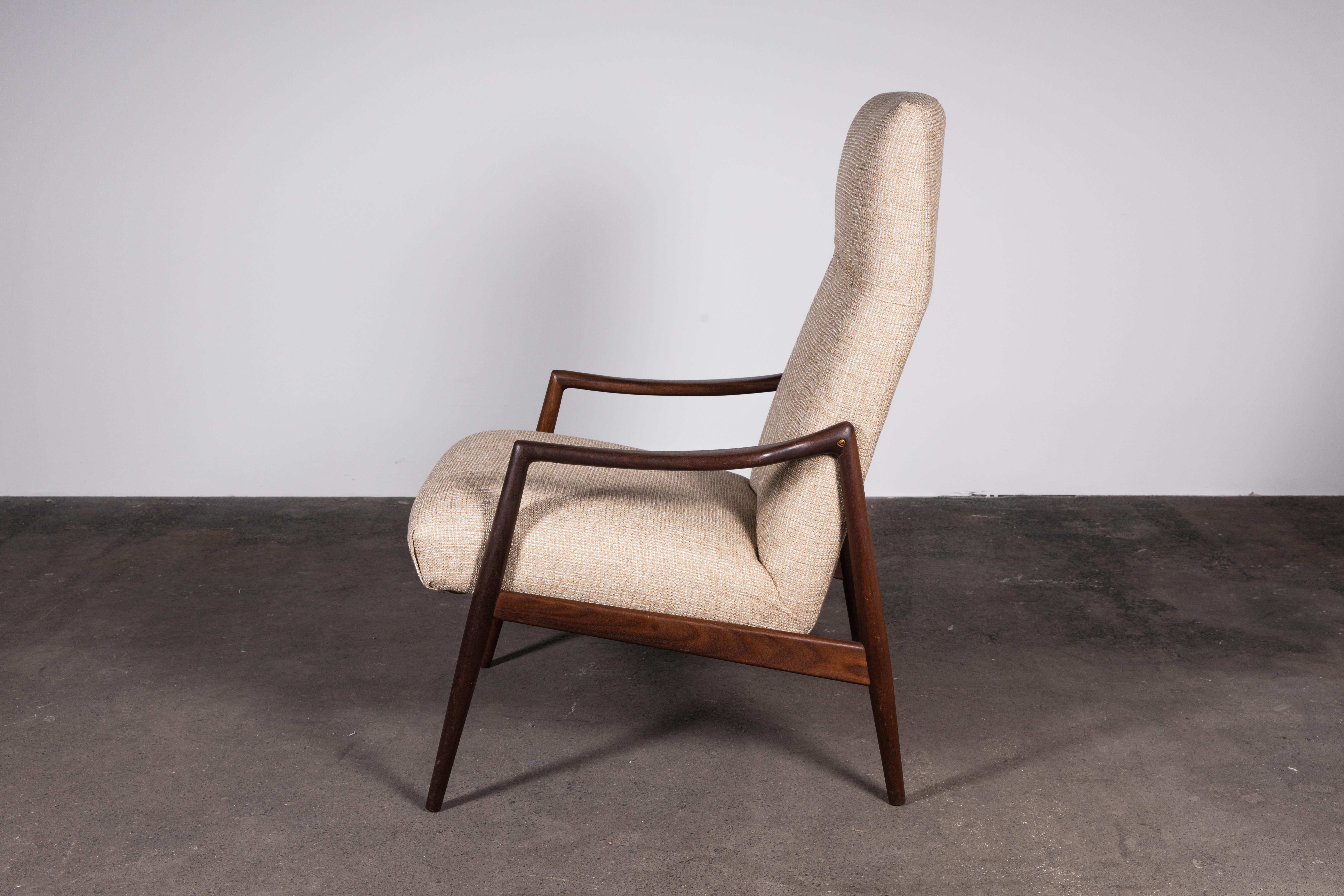 Ships from Kentucky USA.

The epitome of Mid-Century Modern refinement. This iconic high-back teak armchair represents some of the best design and craftsmanship of the era.

The sculpted teak wood, elegantly darkened with age, is complemented by