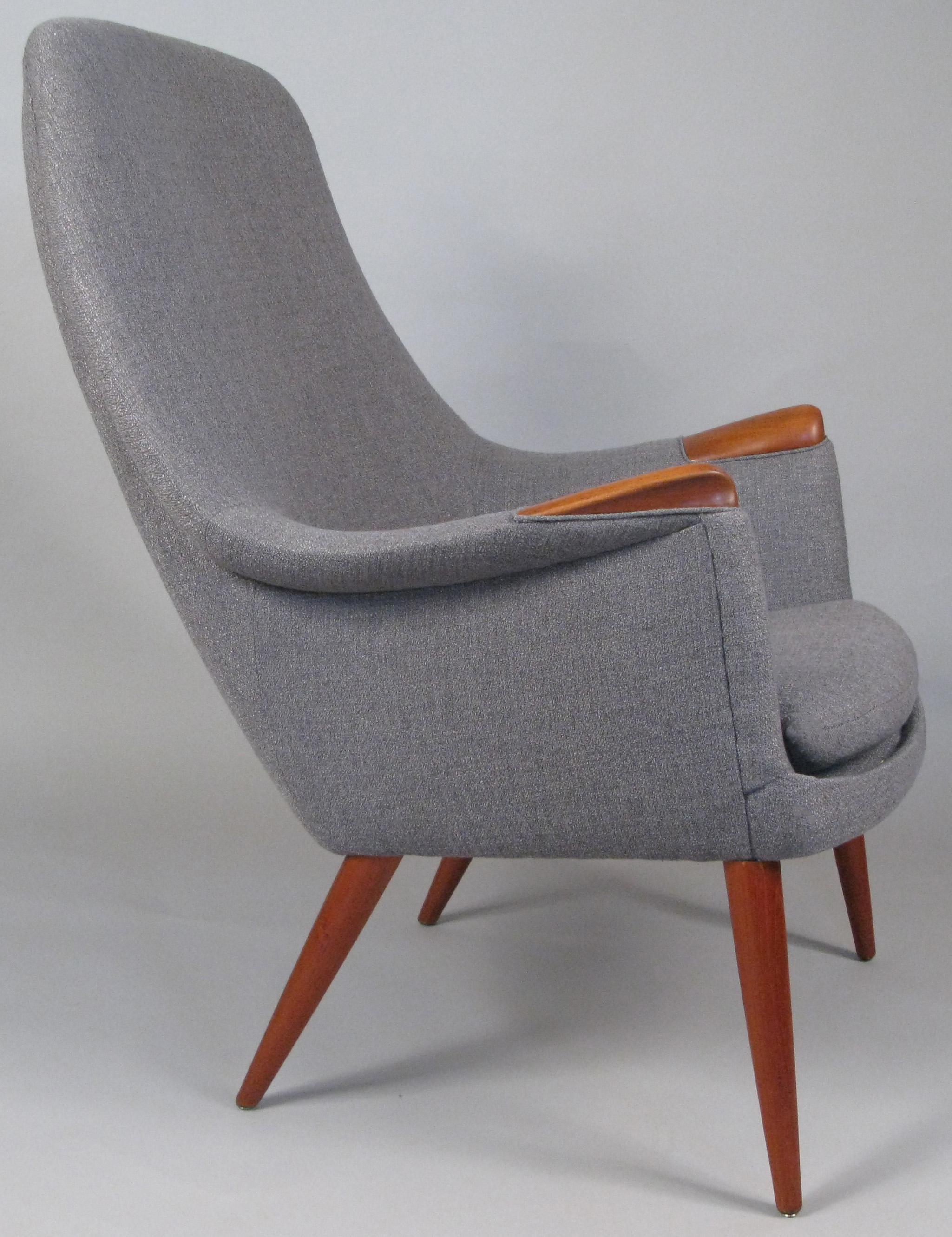 A truly stunning and beautiful 1950s high back lounge chair designed by Gerhard Berg and made by LK Hjelle, with solid teak legs and inset arms. Expertly reupholstered in a soft grey wool fabric.