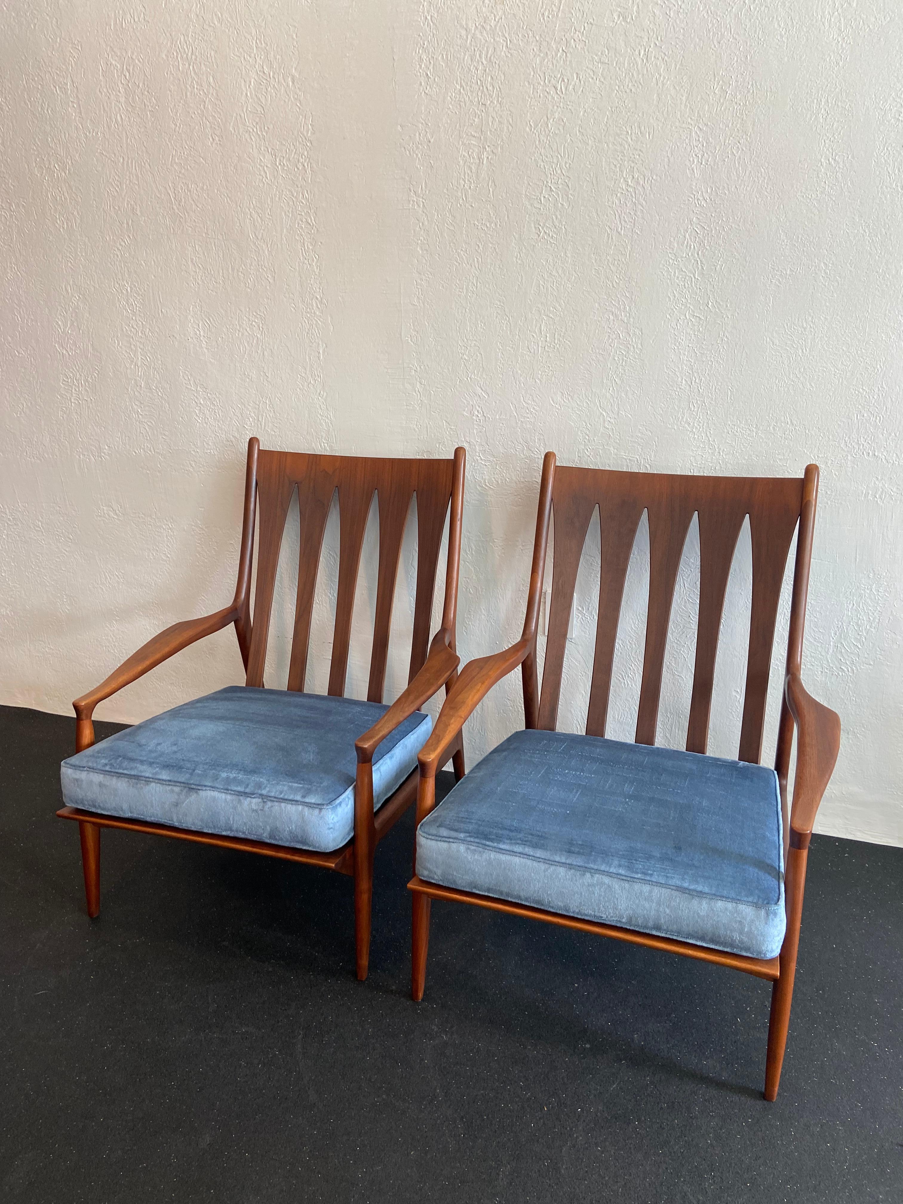 Pair of sculpted walnut high back Archie lounge chairs by Milo Baughman for Thayer Coggin. Upholstery is a velvet blend. Minor wear to the as found vintage upholstery and frames. Chairs have not retained the original manufacturer labels and thus are