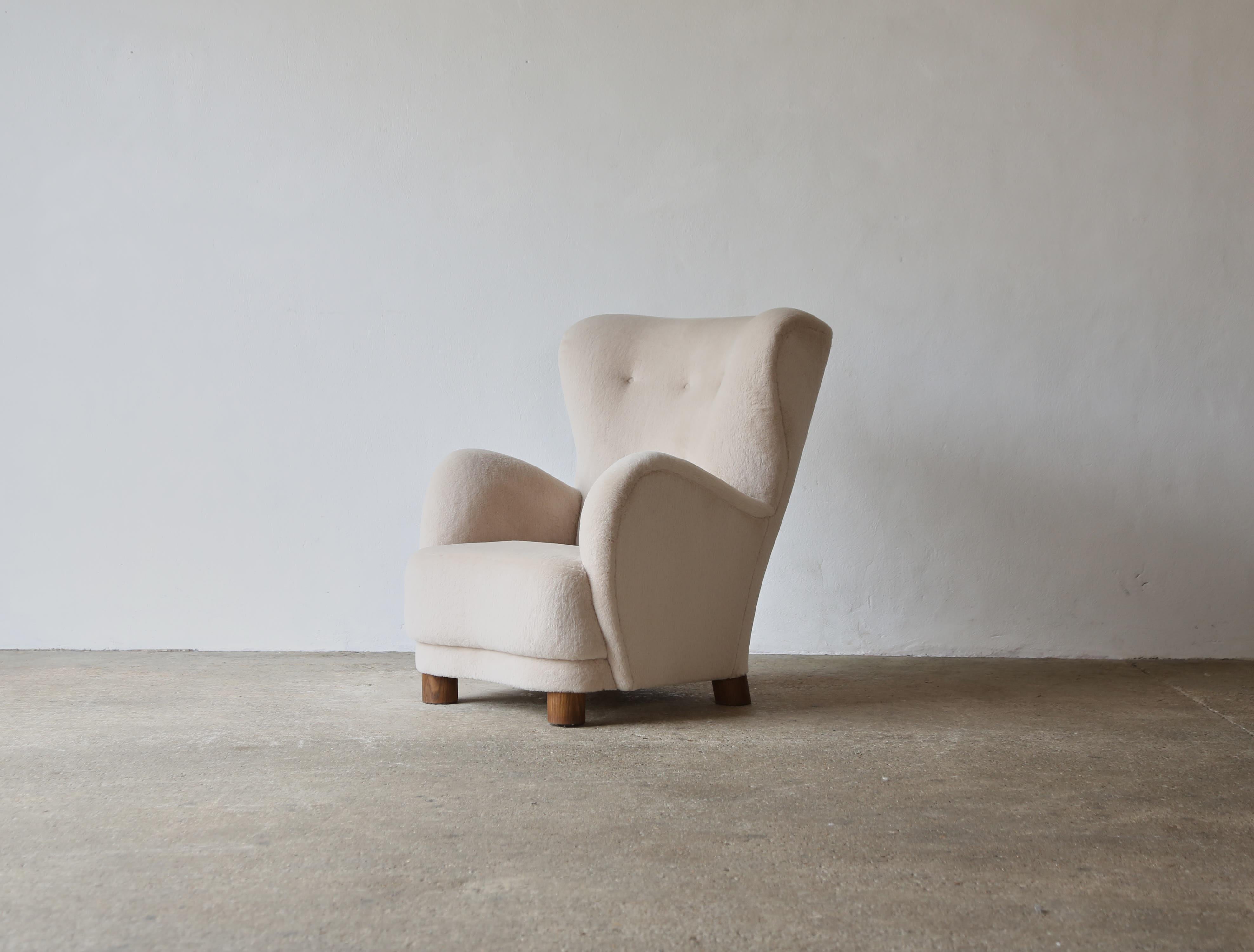 A superb modern high back armchair.  Handmade beech frames, sprung seat and solid oak feet.   Newly upholstered in a luxurious, soft, pure alpaca wool fabric.   Fast shipping worldwide.

