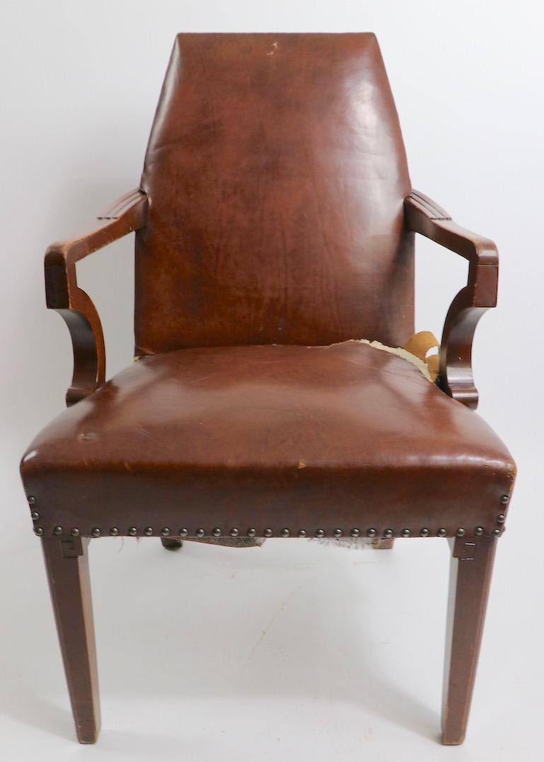 Stylish and well-constructed Art Deco arm, desk, office chair. Solid wood (probably mahogany) frame with carved details, and leather upholstery, needs to be replaced. Solid and structurally sound, wood shows scuffs, and cosmetic scratches. Arm H 28