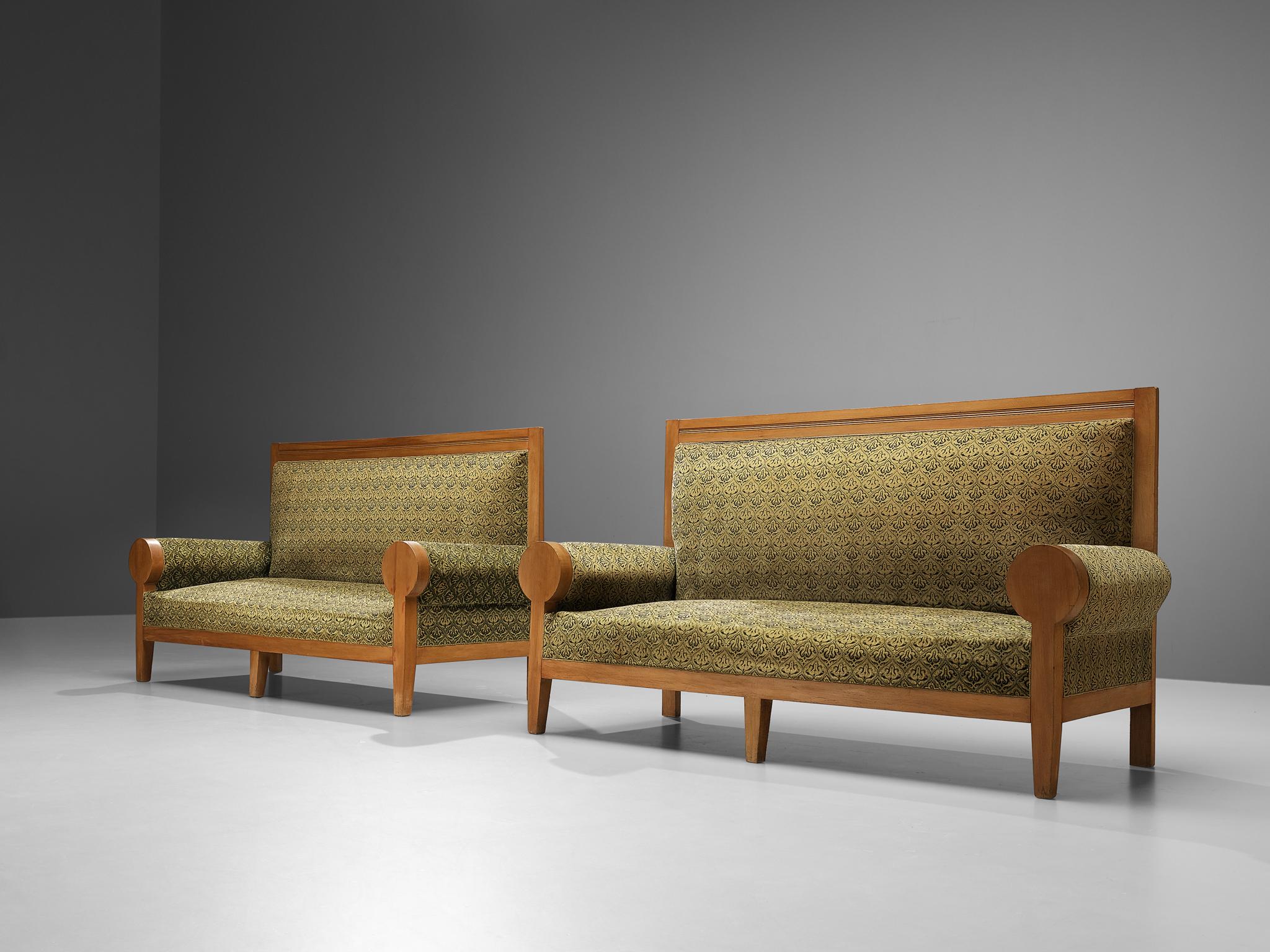 Two sofas, beech, fabric, Europe, 1940s

These sofas has a strong appearance, due the high back and the round armrests that are emphasized by the wooden legs rising upwards. The high backrest is surrounded by beech as well which features carved