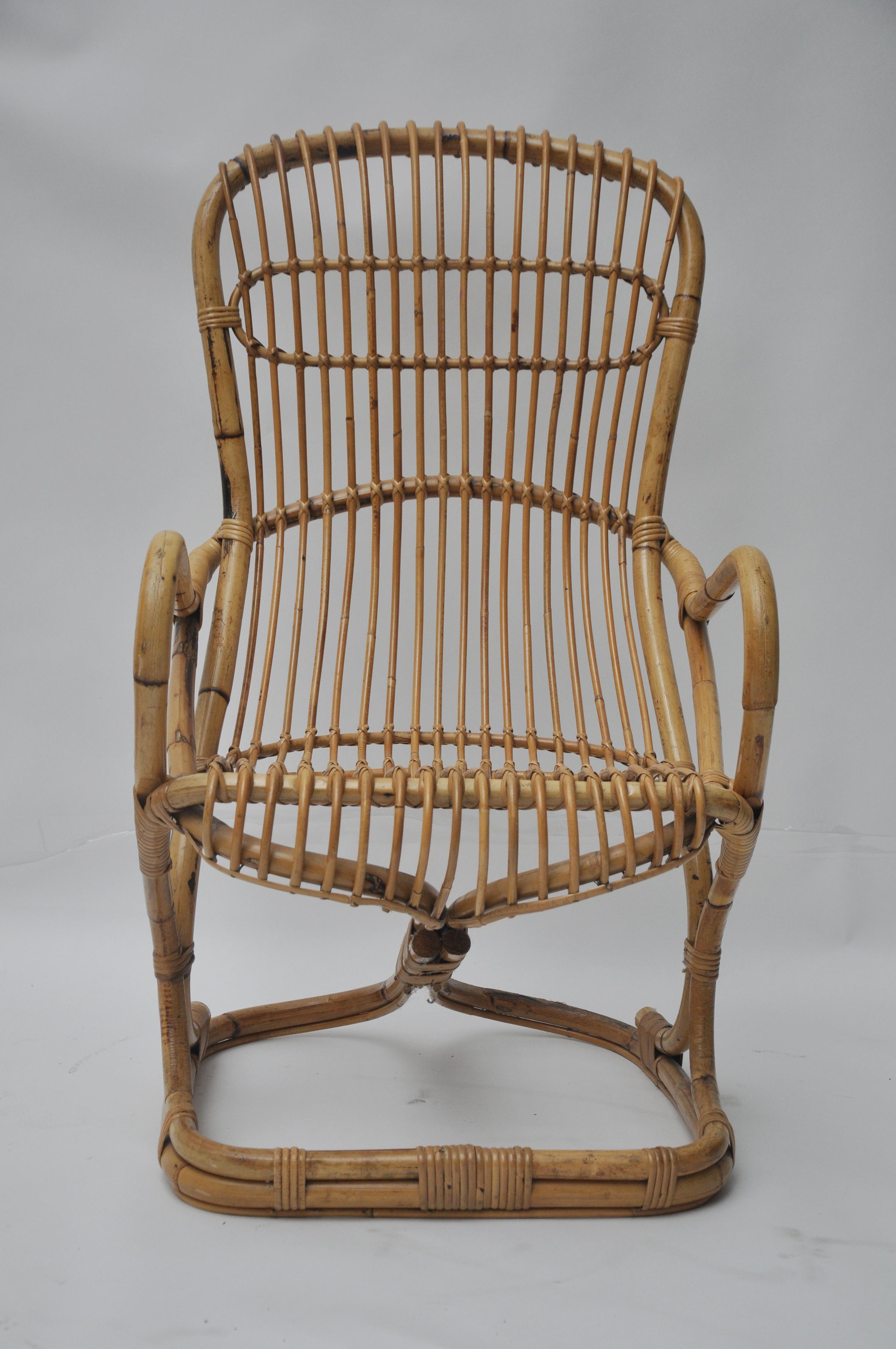 Single midcentury bamboo / rattan lounge chair with arms. High back good original condition with visible patina and minimal rattan loss. This is in the style of Franco Albini. Seat height is 17