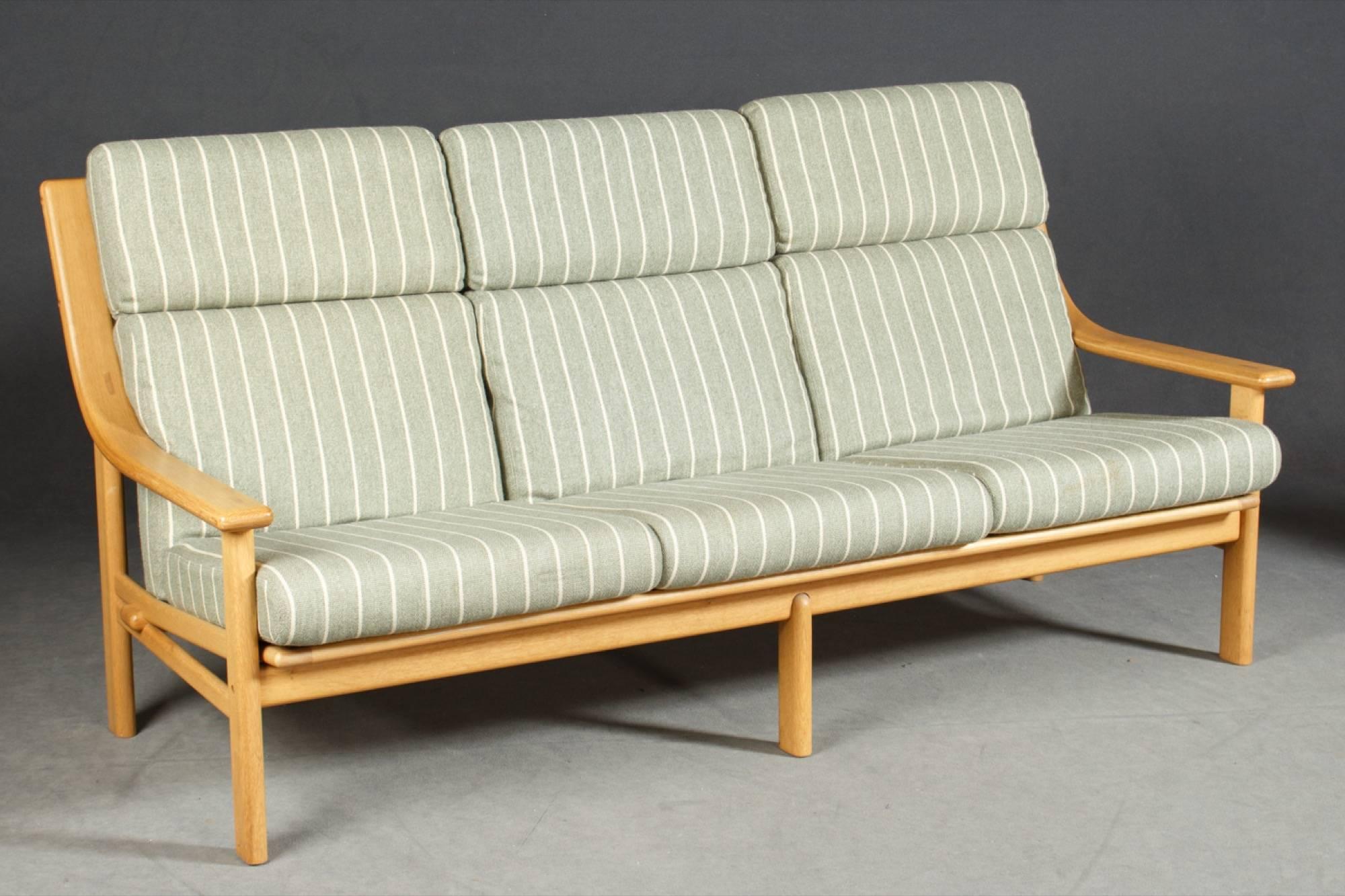 Designed by Johannes Andersen for CFC Silkeborg, this sofa is constructed of a beech frame and three loose cushions.