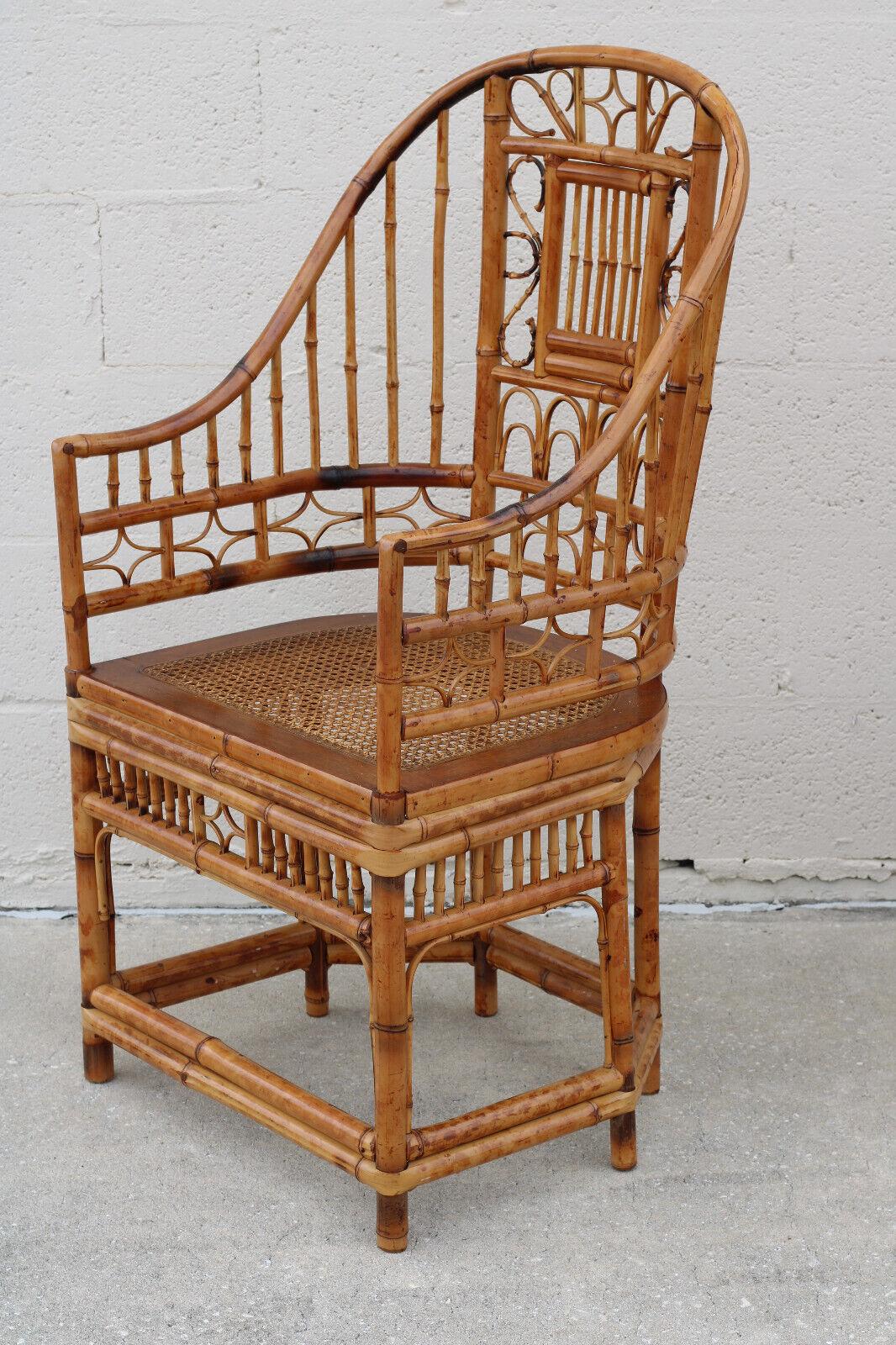 Fabulous pair of high back burnt bamboo armchairs with gracefully shaped horseshoe frames, in the Brighton Pavilion style. These tall beautifully handcrafted Chinese Chippendale chairs feature a tortoiseshell finish, caned-bottom seats, and