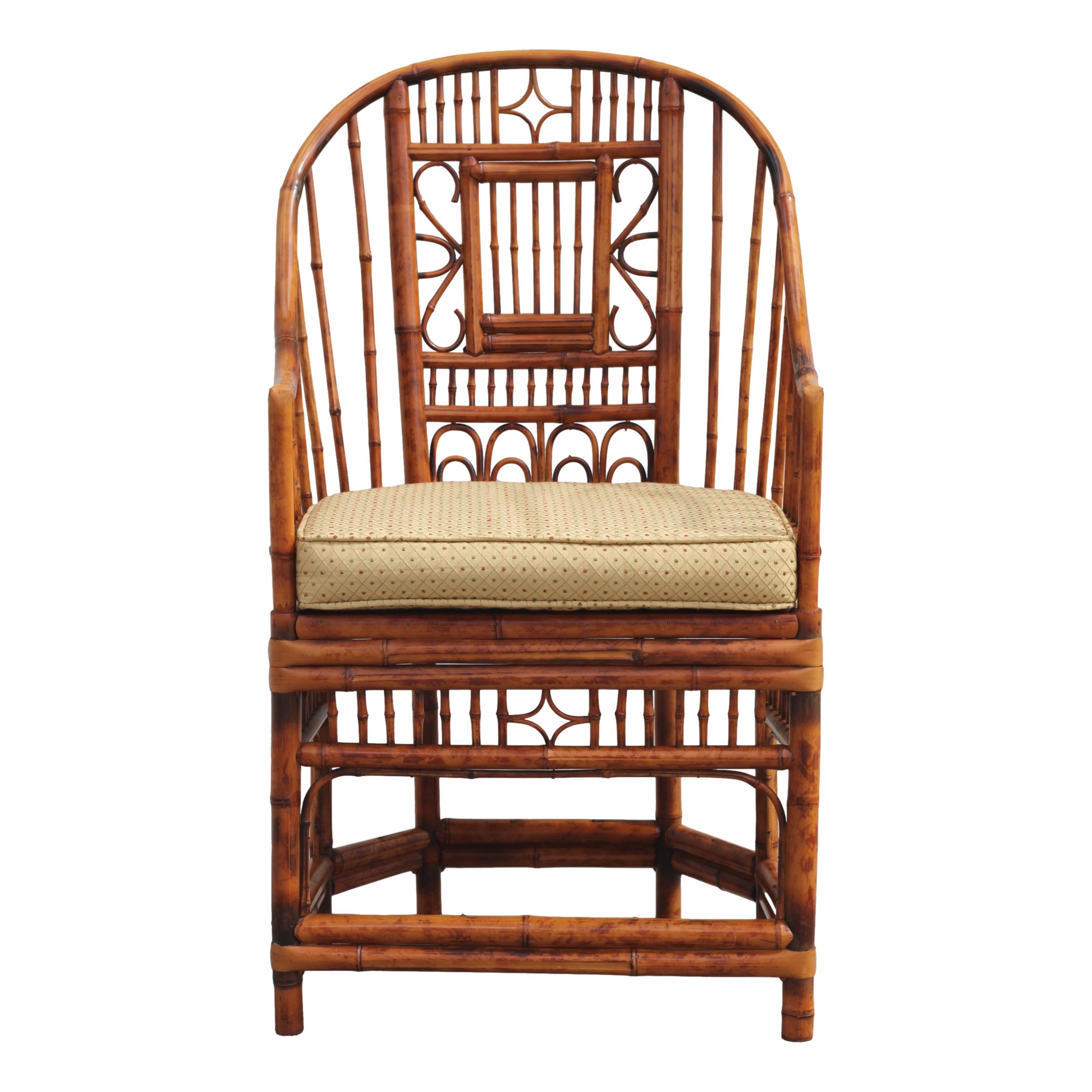 Gorgeous pair of high back burnt bamboo armchairs with gracefully shaped horseshoe frames, in the Brighton Pavilion style. These tall beautifully handcrafted Chinese Chippendale chairs feature a tortoiseshell finish, caned-bottom seats, and