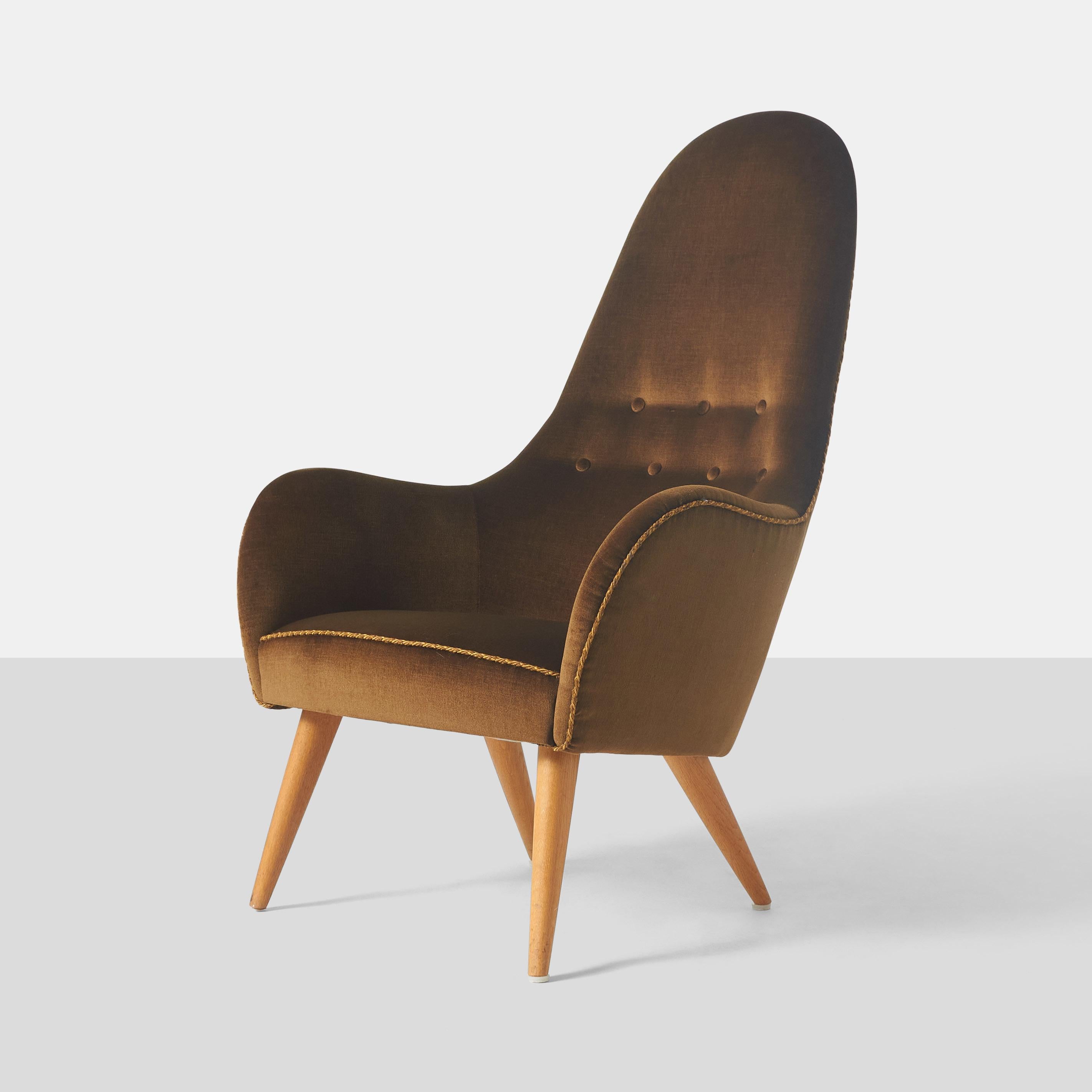 A tufted high back Adam lounge chair from the Paradise collection by Kerstin Horlin-Holmquist for Nordiska Kompaniet with beech legs and upholstered in a brown fabric and twisted cord trim detail along the seat and back edges.

A matching sofa and