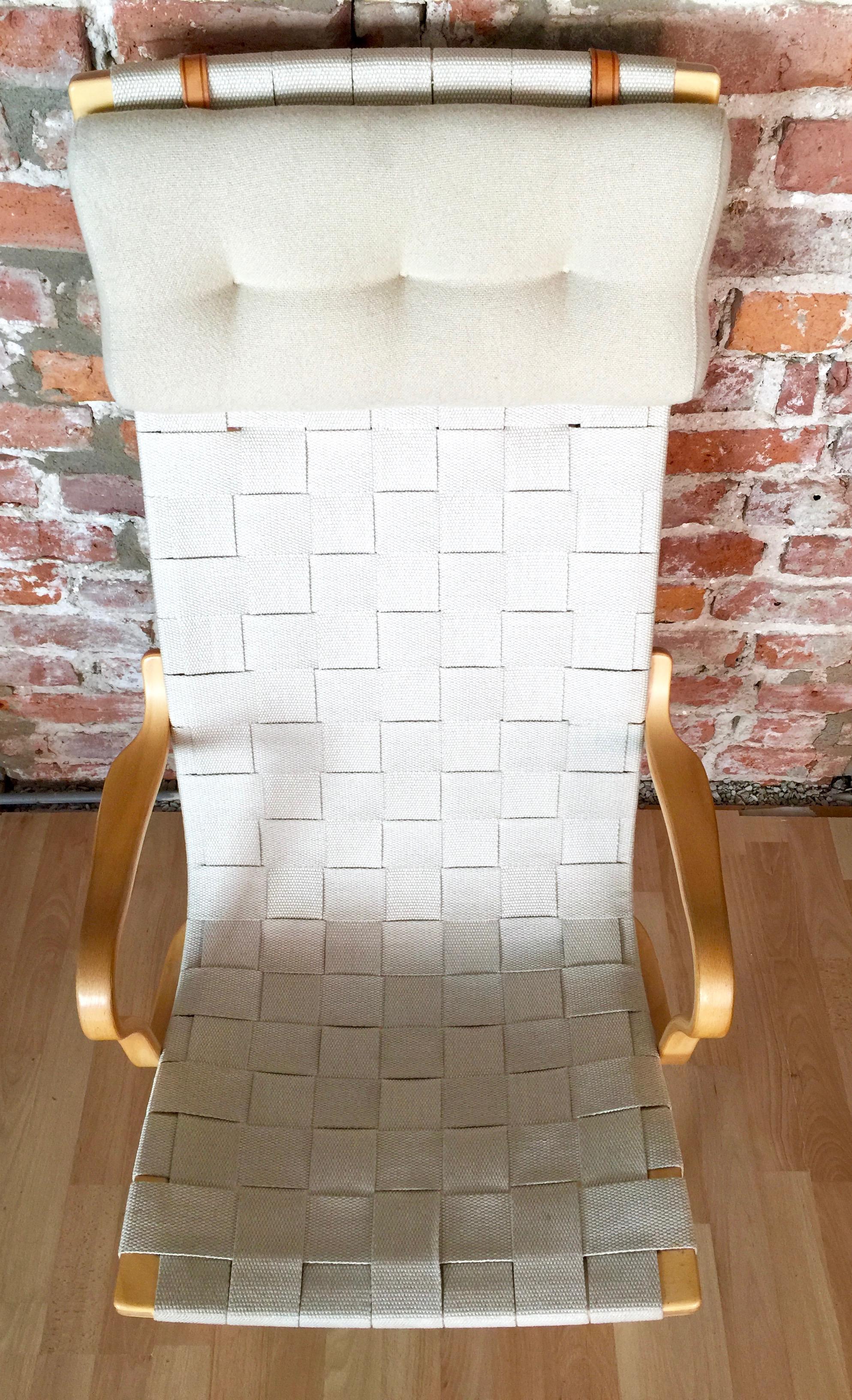 A high back Eva chair originally designed by Bruno Mathsson in the mid-1930s. This chair is made of beech and comes with linen webbing and linen pillow. Excellent stand.