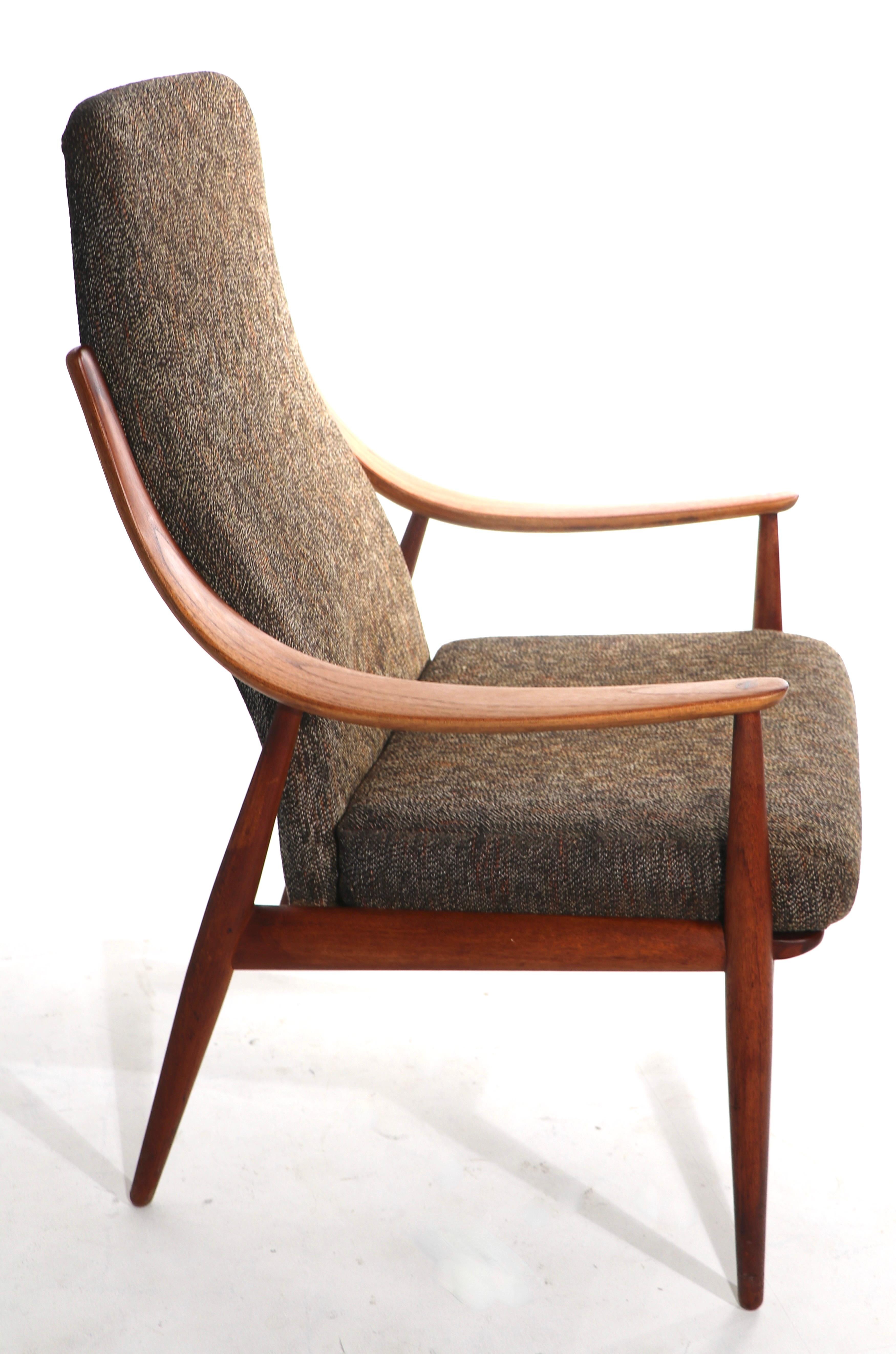 Dramatic high back version of the iconic Hvidt - Molgaard lounge chair, made by France and Daverkorsen, distributed by John Stuart Inc. This example is in very fine, original, untouched condition, clean and ready to use. Solid teak frame supports