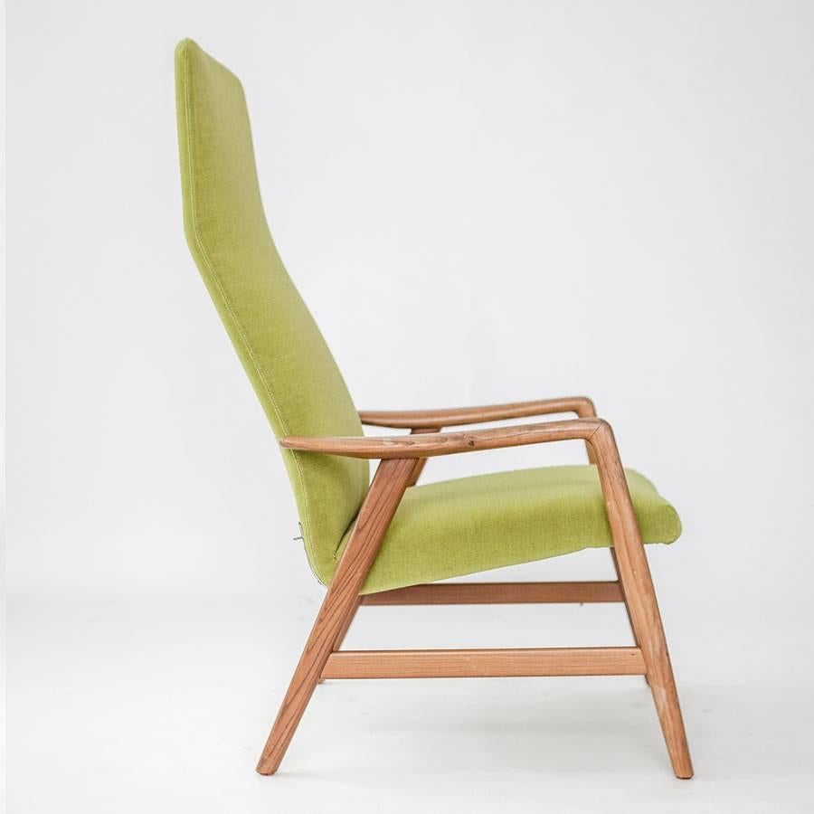 High back lounge chair in teak, upholstered in green Kwadrat fabric.