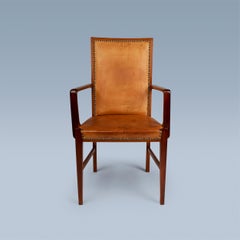 High back nut wood armchair with leather seat and back by Danish cabinetmaker