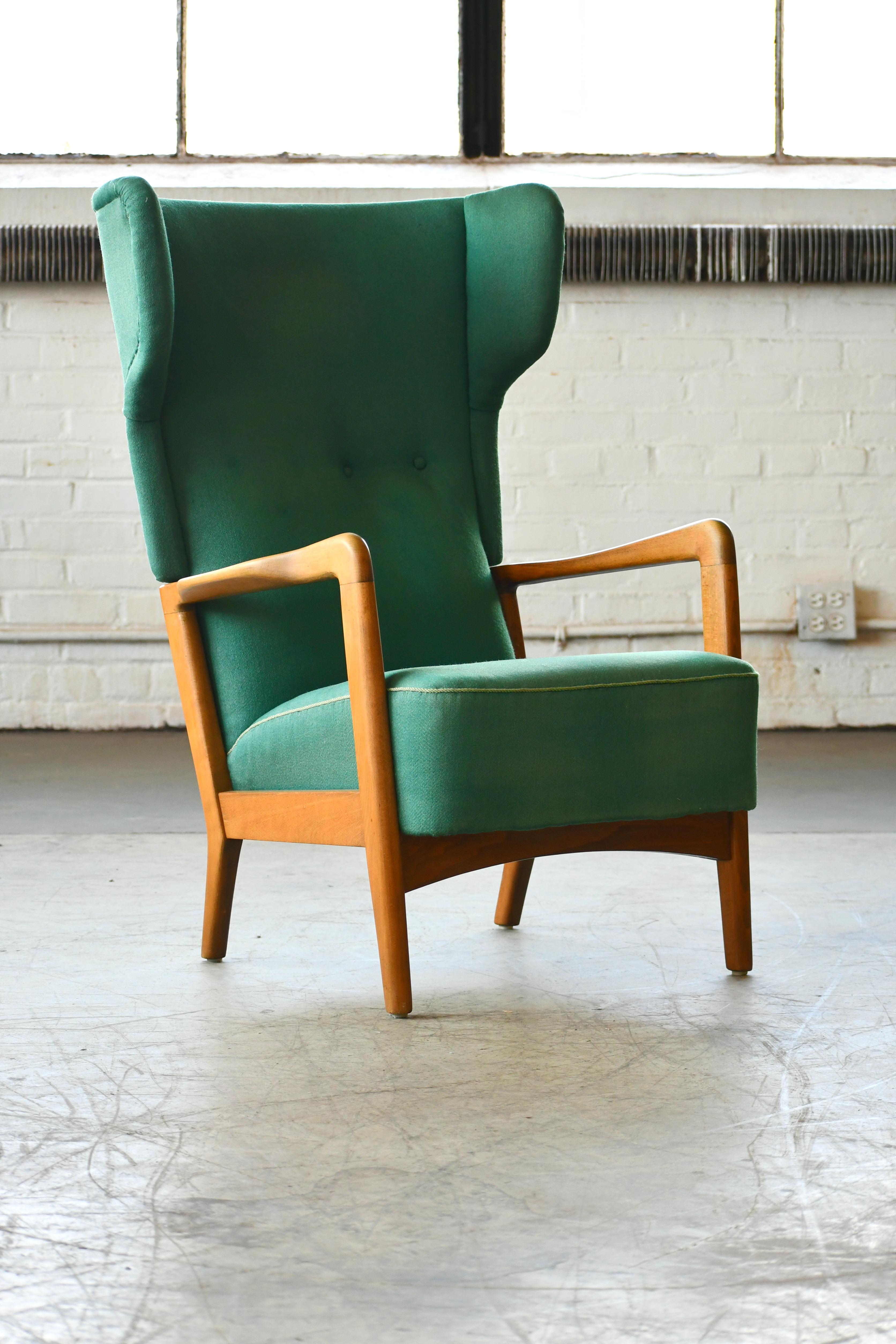 Classic Fritz Hansen high back lounge chair with open armrests designed by Soren Hansen and manufactured in the 1940s by Fritz Hansen. One of Fritz Hansen's most enduring designs elegant and comfortable. Nicely grained elm frame later upholstered in