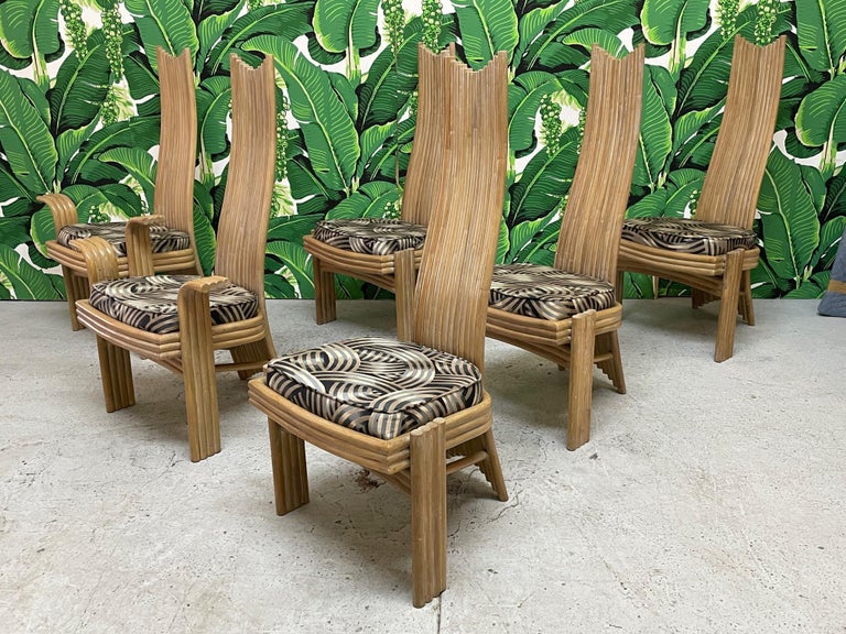 Rare set of six high back rattan dining chairs echoing the styles of Danny Ho Fong or Mackintosh. Unique modern sculptural design with two arm chairs and four side chairs. Good condition with imperfections consistent with age. May exhibit scuffs,