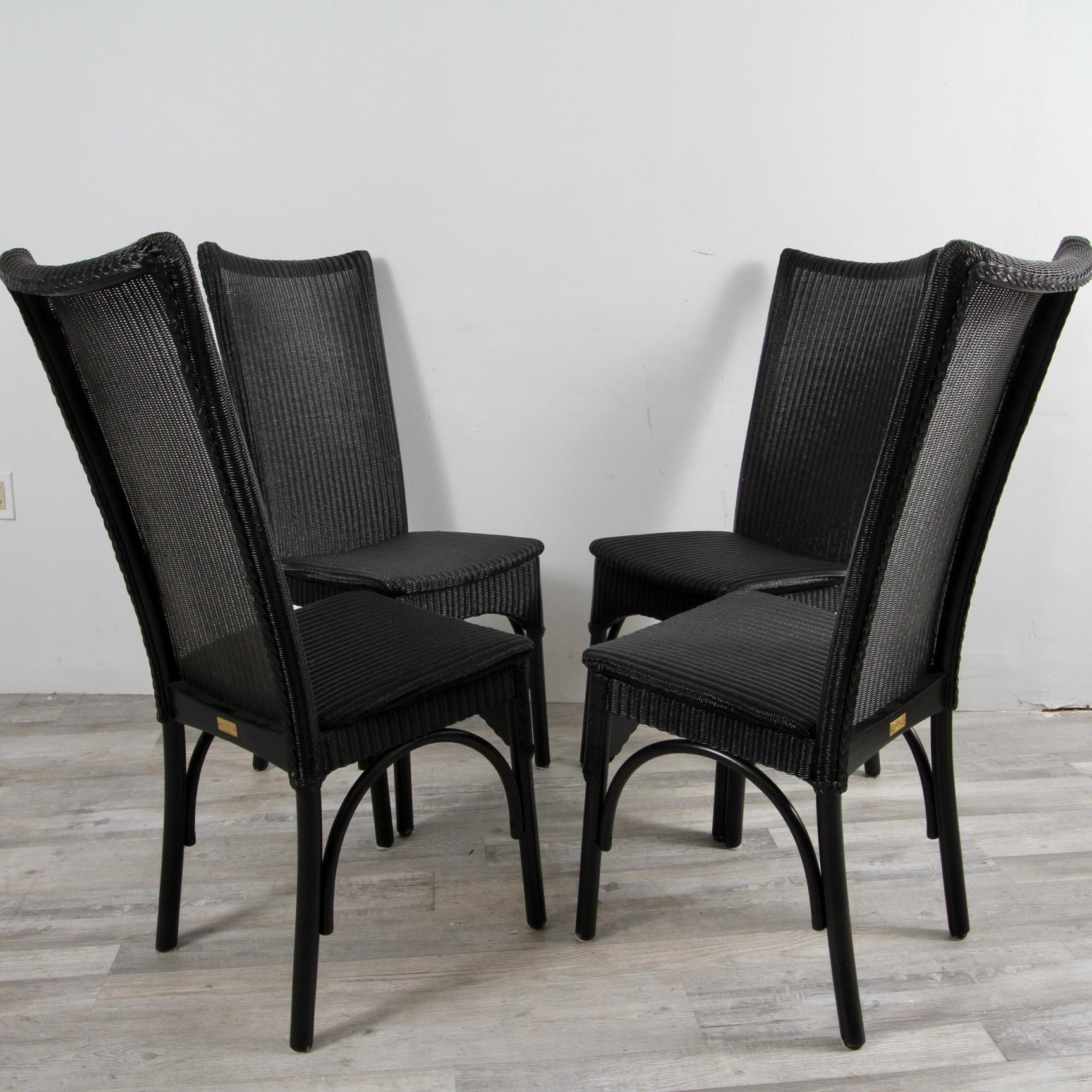 Clean set of 4 Loom Italia ebony wicker dining chairs. 

Lloyd Loom was invented by an American, Marshall Burns Lloyd, in 1917. He came up with an idea for an innovative woven material that would offer the benefits of wicker and rattan, without