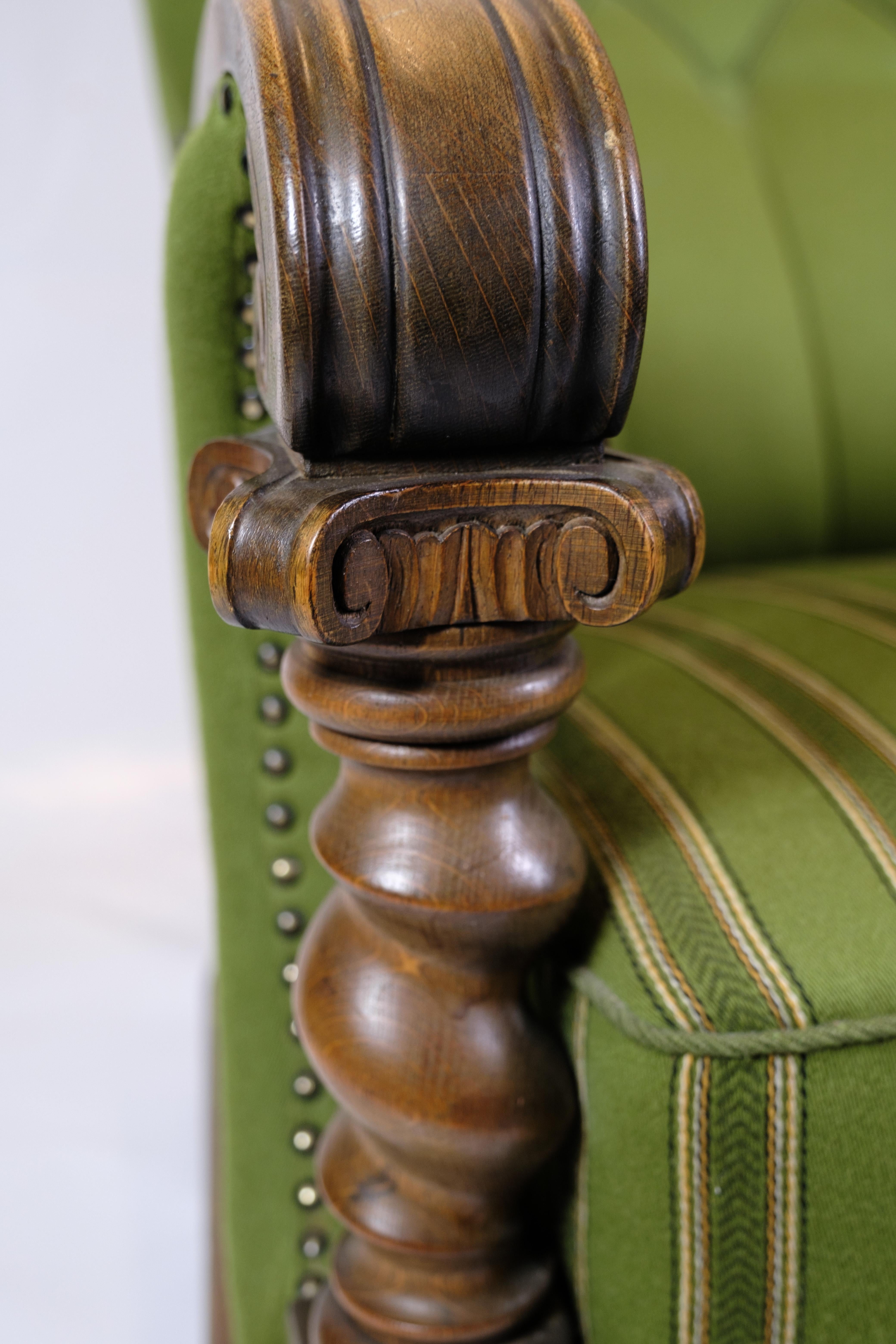 Fabric High-backed Armchair in Green fabric with Wood Carvings from 1920s. For Sale
