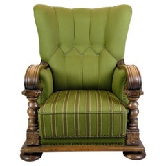 Antique High-backed Armchair in Green fabric with Wood Carvings from 1920s.
