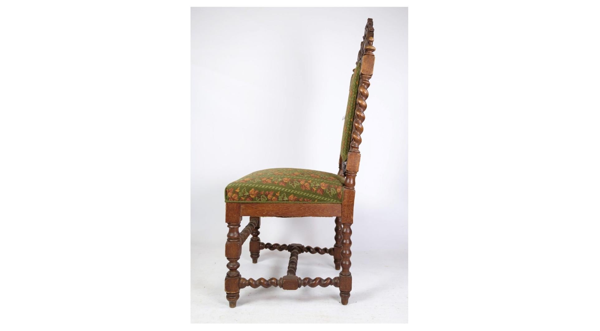 The high-backed chair crafted from solid oak, echoing the Renaissance style from around the year 1910, is a remarkable piece of furniture that exudes timeless elegance and sophistication. Inspired by the opulent designs of the Renaissance period,