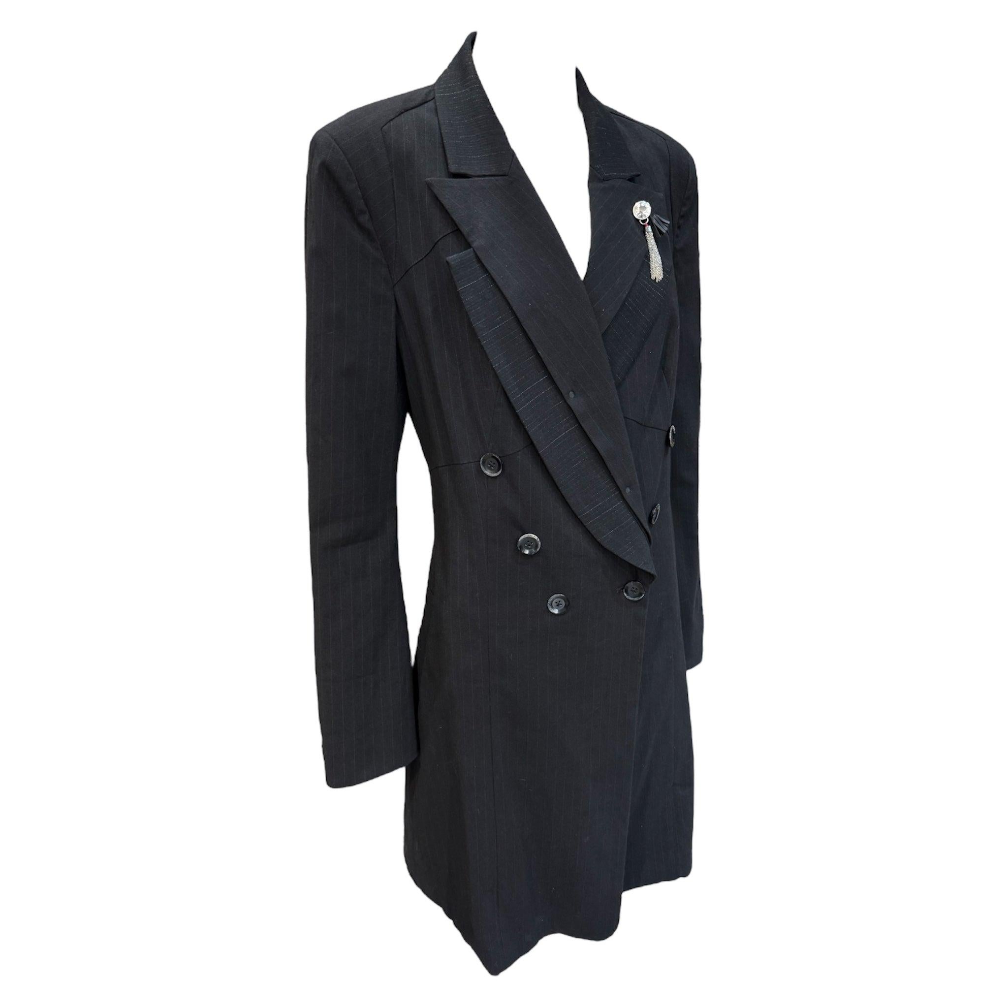 Avant garde black tuxedo style trench coat by contemporary label, HIGH Everyday Couture. Circa 2000's. Double breasted tuxedo silhouette with double layered notched lapels. Layered lapels are both pinstriped layered in juxtaposing directions.