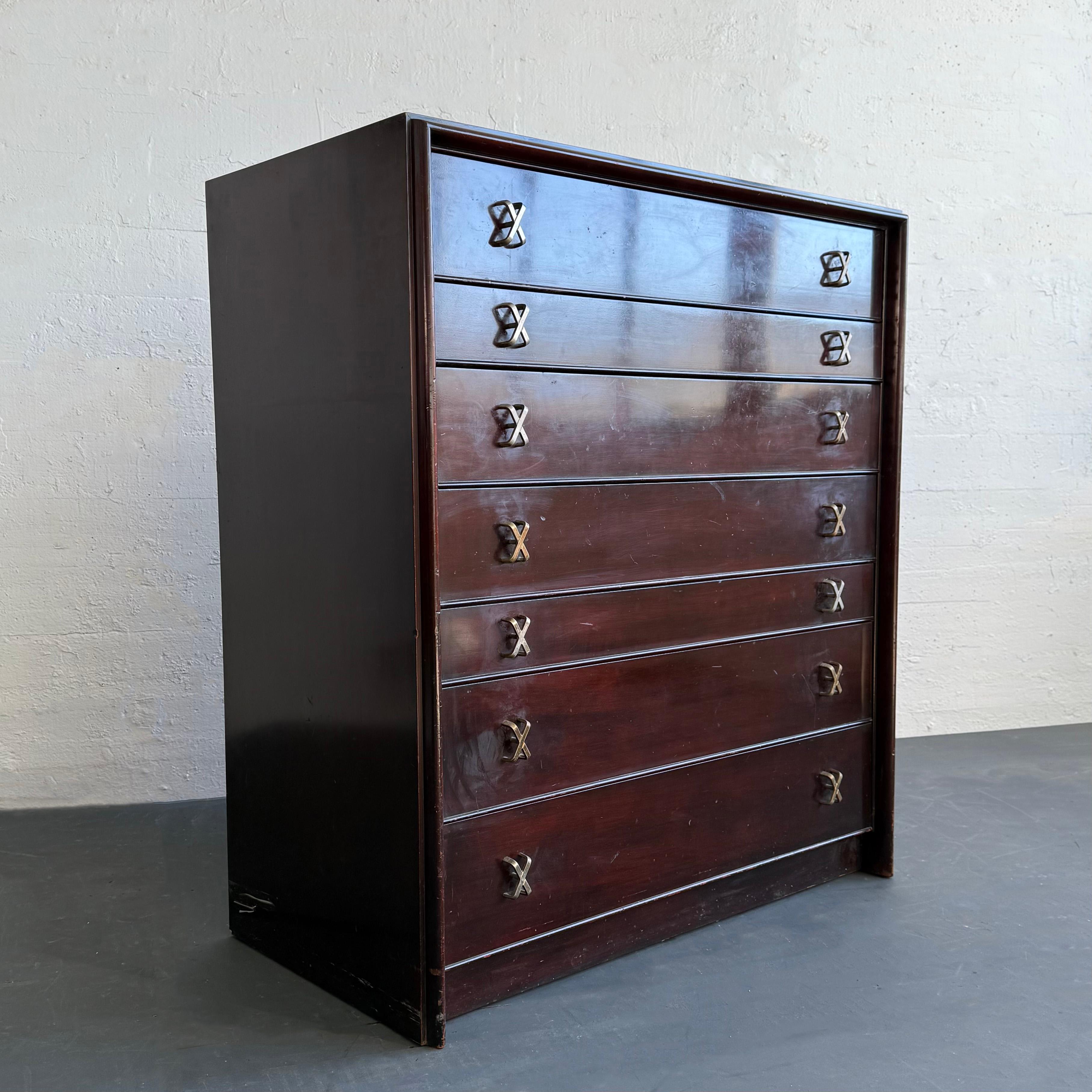 This vintage gem is designed by the iconic and prolific Paul Frankl for Johnson Furniture Co. retailed by John Stuart in the heart of New York City, circa 1950s. This highboy dresser is made of dark lacquered mahogany featuring a lovely rectilinear