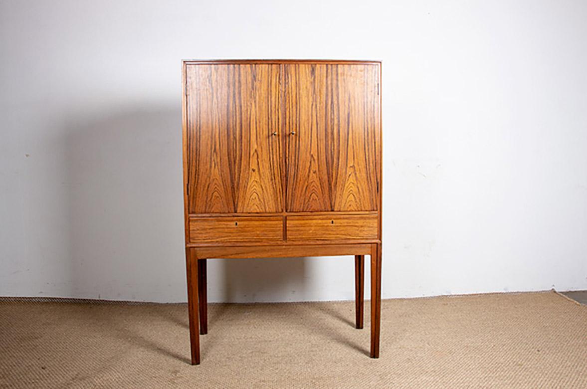 Superb Scandinavian bar cabinet. The lower section features two lockable drawers (keys provided), and the upper section features two hinged doors (keys provided). The left-hand niche features two shelves and two interior drawers. The right-hand