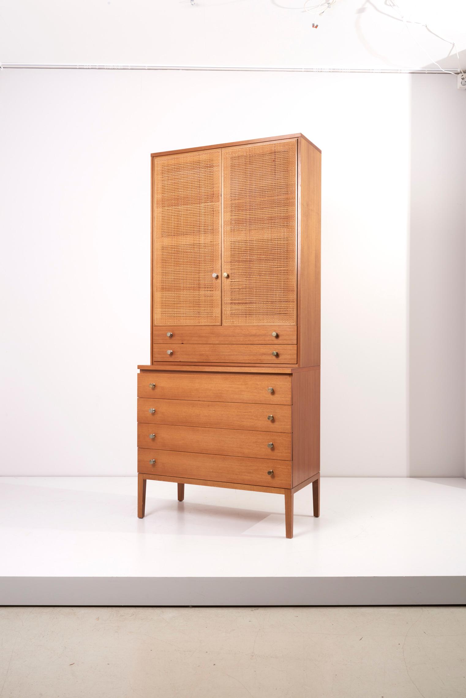 Towering high cabinet or board designed by Paul McCobb for Directional / WK Möbel. Walnut with original polished metal pulls. The cabinet exists of a chest with four drawer and a cabinet or credenza consisting of two drawer and a storage section