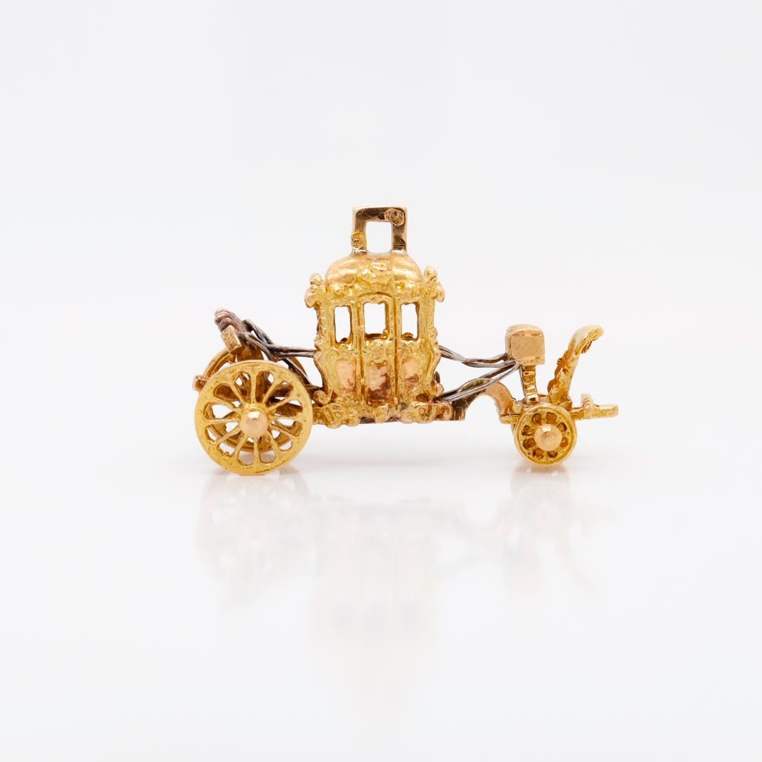 A fine vintage gold charm for a charm bracelet.

In 19k (or 800 gold).

In the form of a coach or stagecoach.

With white gold straps and braces, functional wheels and an integral bail to the carriage's roof.

Simply a wonderful charm!

Date:
20th