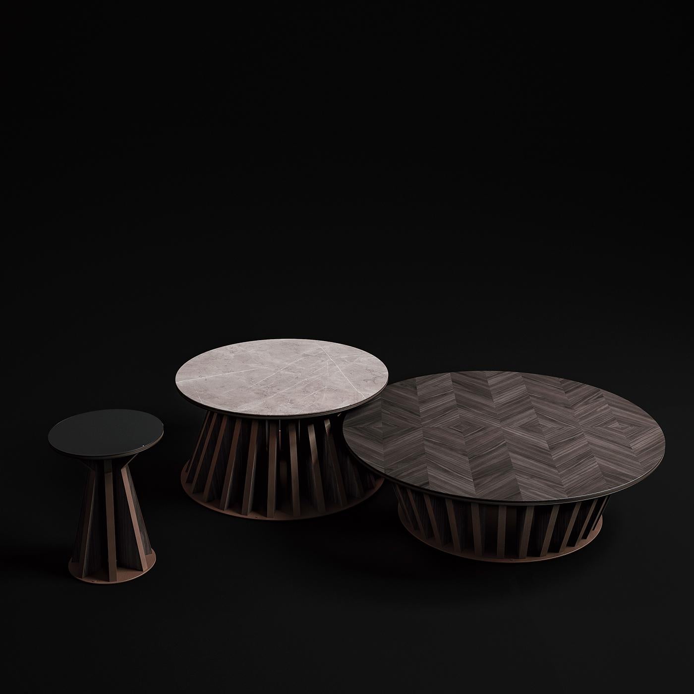 Characterized by the use of warm natural walnut wood and cool lacquered glass, the high side table brings Classic materials into the contemporary realm. With a round base and tabletop, the table plays with geometry through the use of diagonal spokes