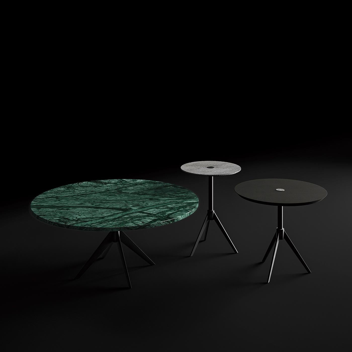 The high coffee table is characterized by an engraved design on the marble top and a chic, clean style that makes it the perfect addition to any contemporary style decor. The metal base is formed by a central pole that joins on to three legs that