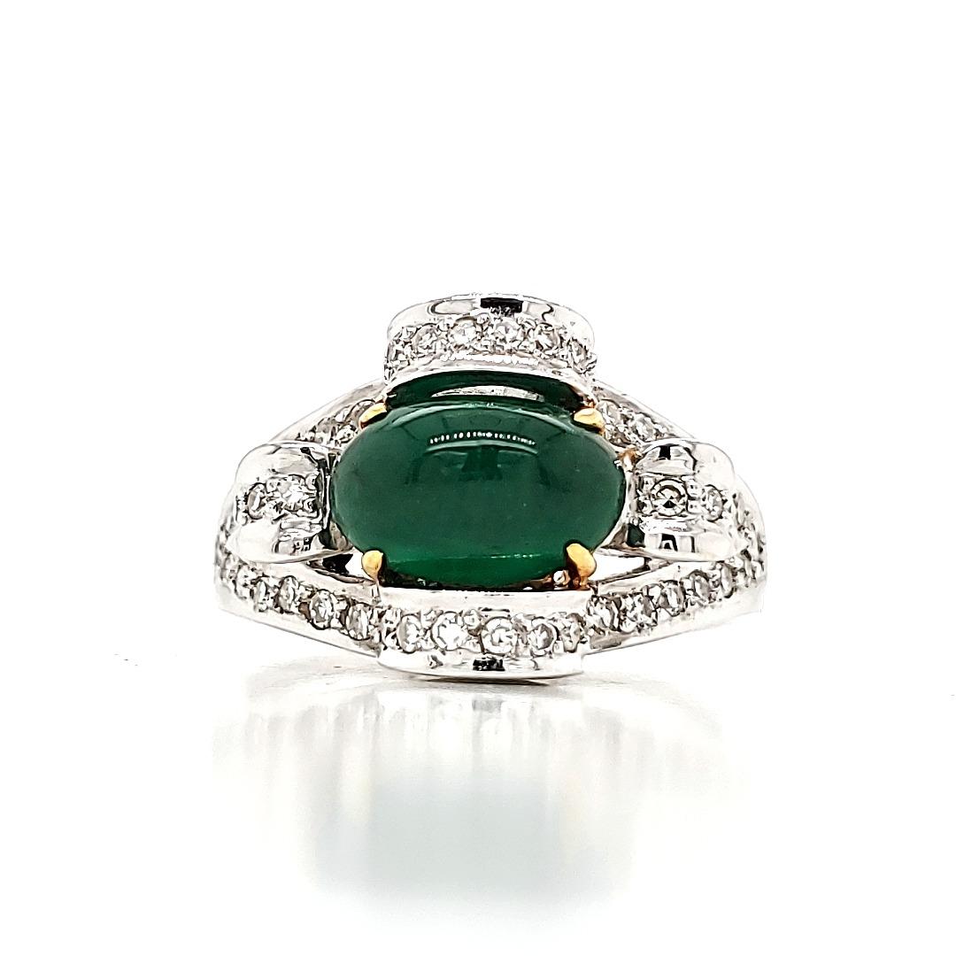High dome oval emerald cab ring with diamonds and gold.

Emerald cabochones traditionally adorned the crowns and jewels of all royalty in India and subsequently many treasured jewellery items of the Kings and Queens of England for many centuries.