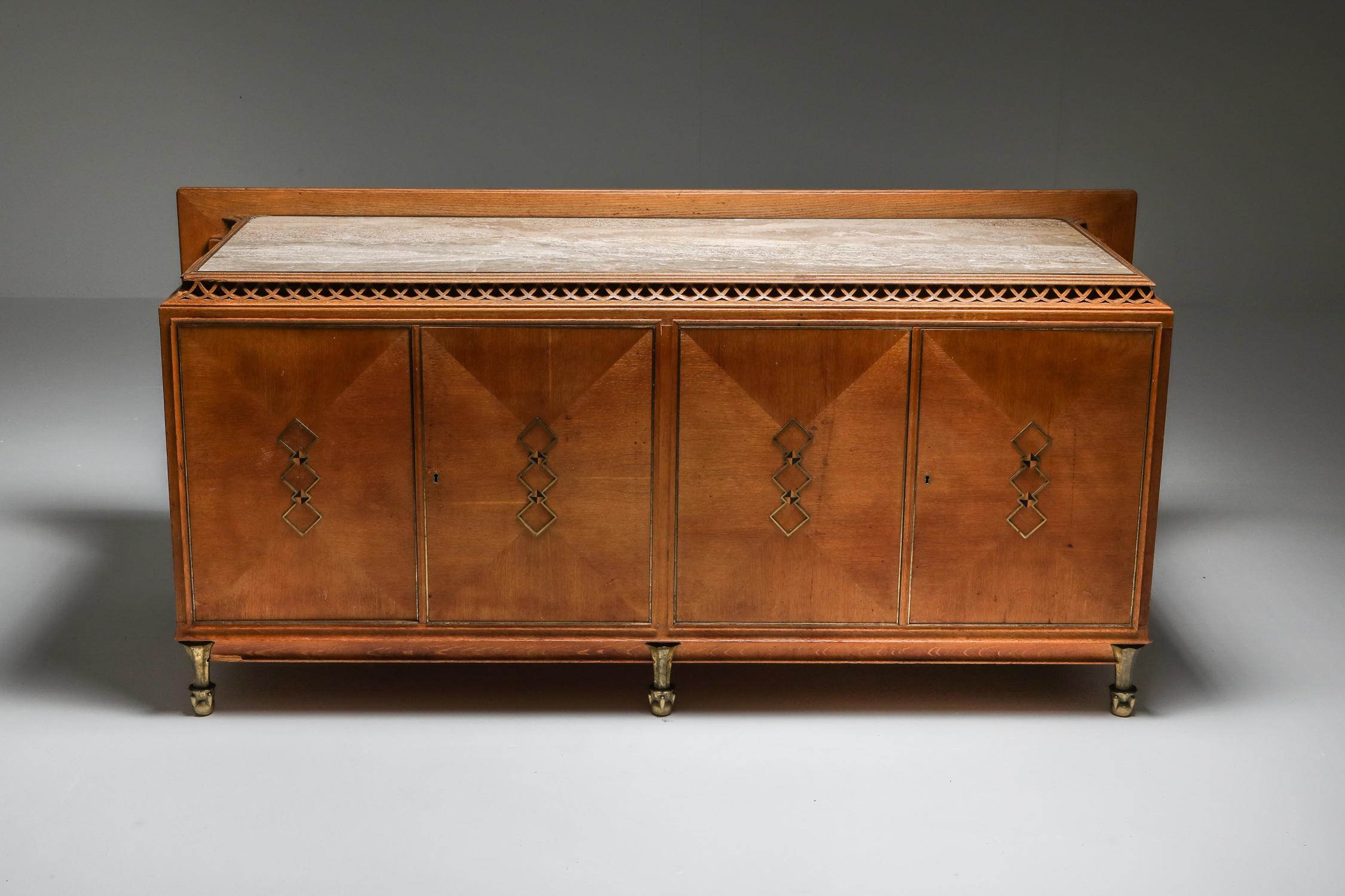 Art Deco style high-end sideboard with stunning details, France, 1930s

Luxury storage piece, marble top, bronze feet, carved oak.

Previously owned by an architect who had the inside converted to store his drawings.
We have two pieces