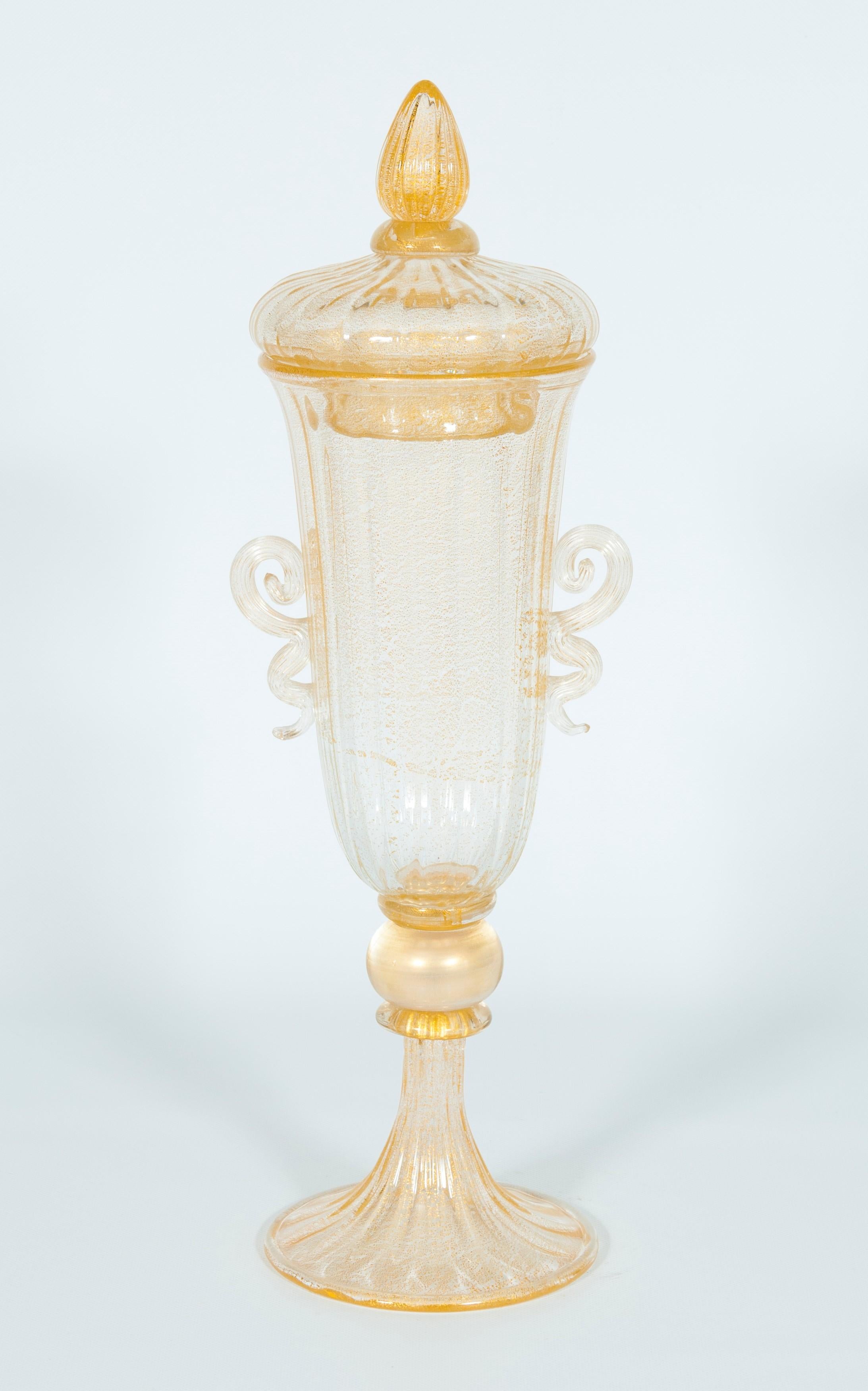 High-End Murano Glass Goblet with Lid and Gold Finishes Italy 1960s.
This mouth-blown transparent Murano glass goblet with gold finishes is pure beauty. Imagine placing this goblet at the center of the main table near a set of candleholders, and