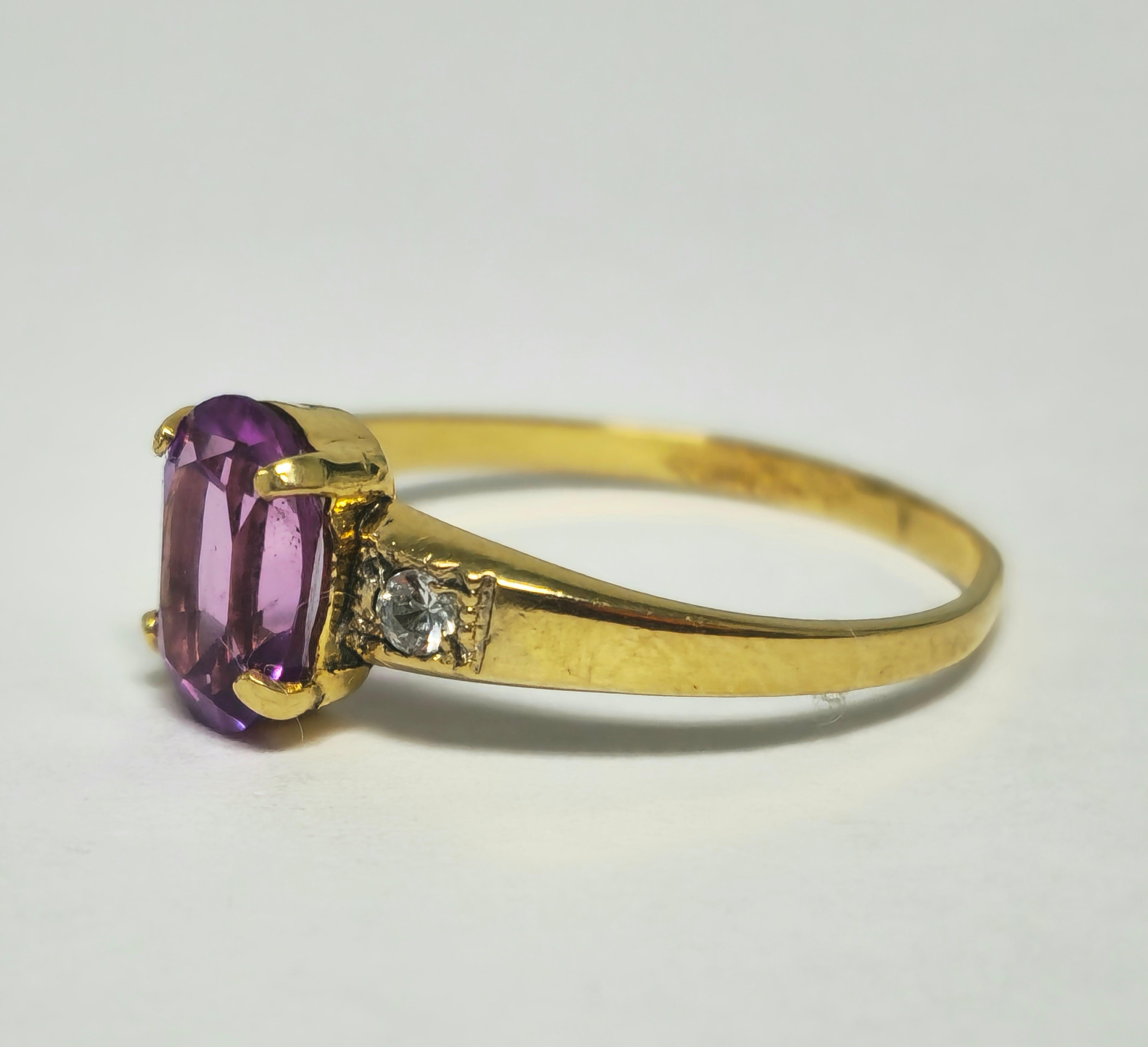 Fashioned in 10K yellow gold, this captivating ring boasts a centerpiece of a 0.95-carat pink sapphire, its natural elegance accentuated by its oval shape. Surrounding it are diamonds totaling 0.12 carats, with SI2 clarity and G color, adding a