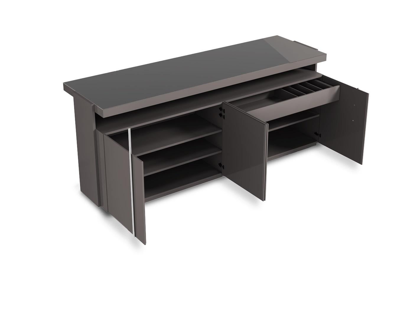This bar table showcases a contemporary design with a high-gloss lacquer finish that adds a sleek and polished touch to its bold silhouette. The structure features clean lines and metallic accents, creating a refined and modern aesthetic. Its