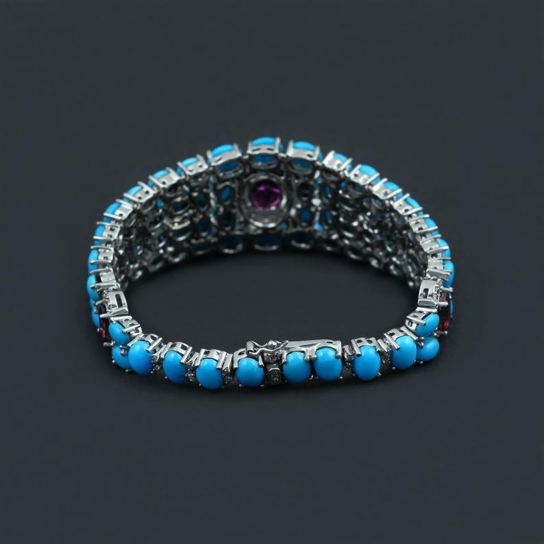 This 34.49 CT Sleeping Beauty Turquoise and Genuine 1.39 CT Diamond Sterling Silver Bracelet is nothing short of a piece of art with three Tourmaline Gemstones weighing 6 CT's making it a tasteful design to adorn your lovely wrist.