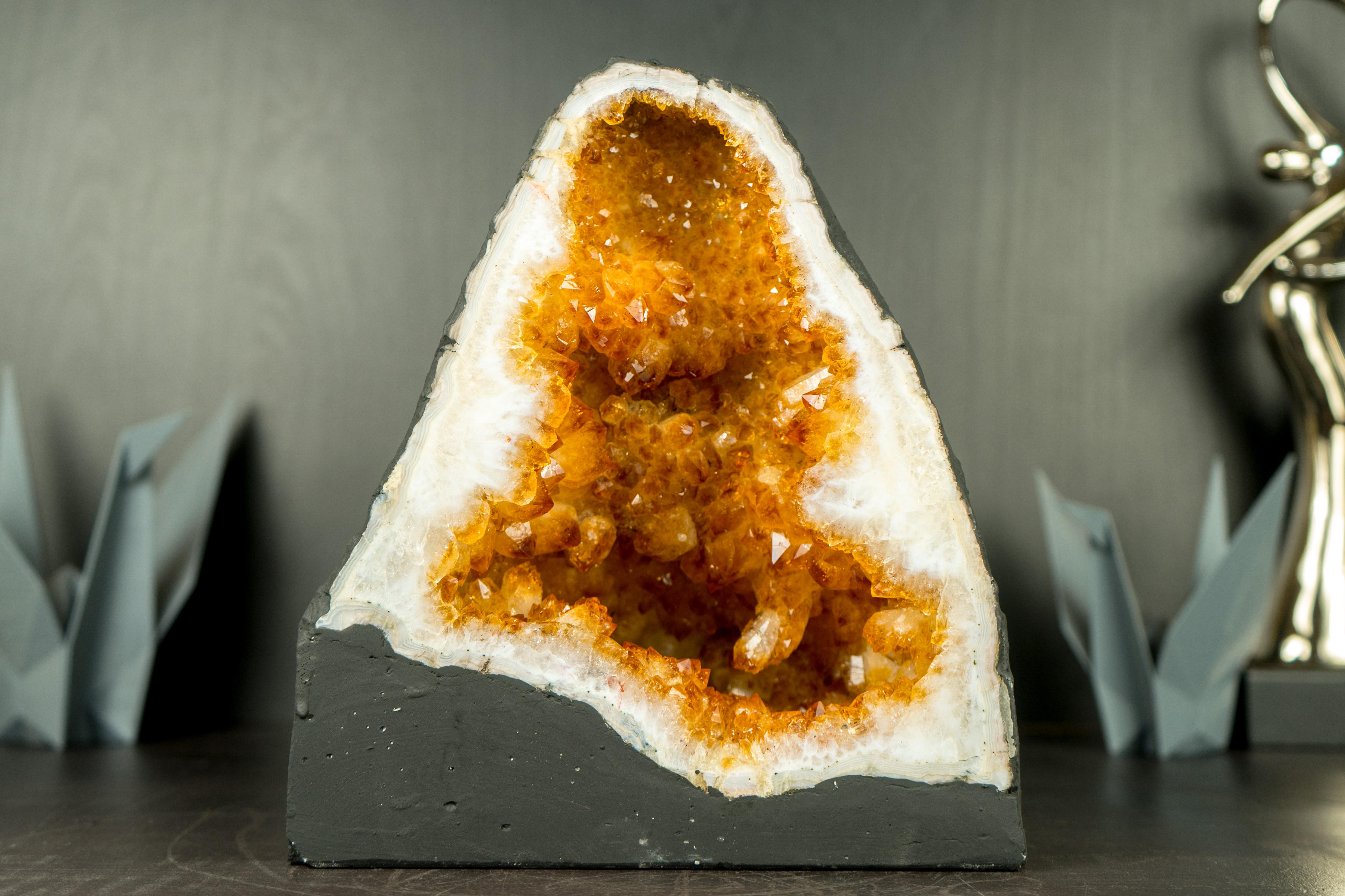 With its golden orange color tone and natural, beautiful cave-like shape, this Citrine Geode is a fabulous small Citrine that will undoubtedly serve as a stunning accent piece, seamlessly adding to any space or complementing Feng Shui practices.

In