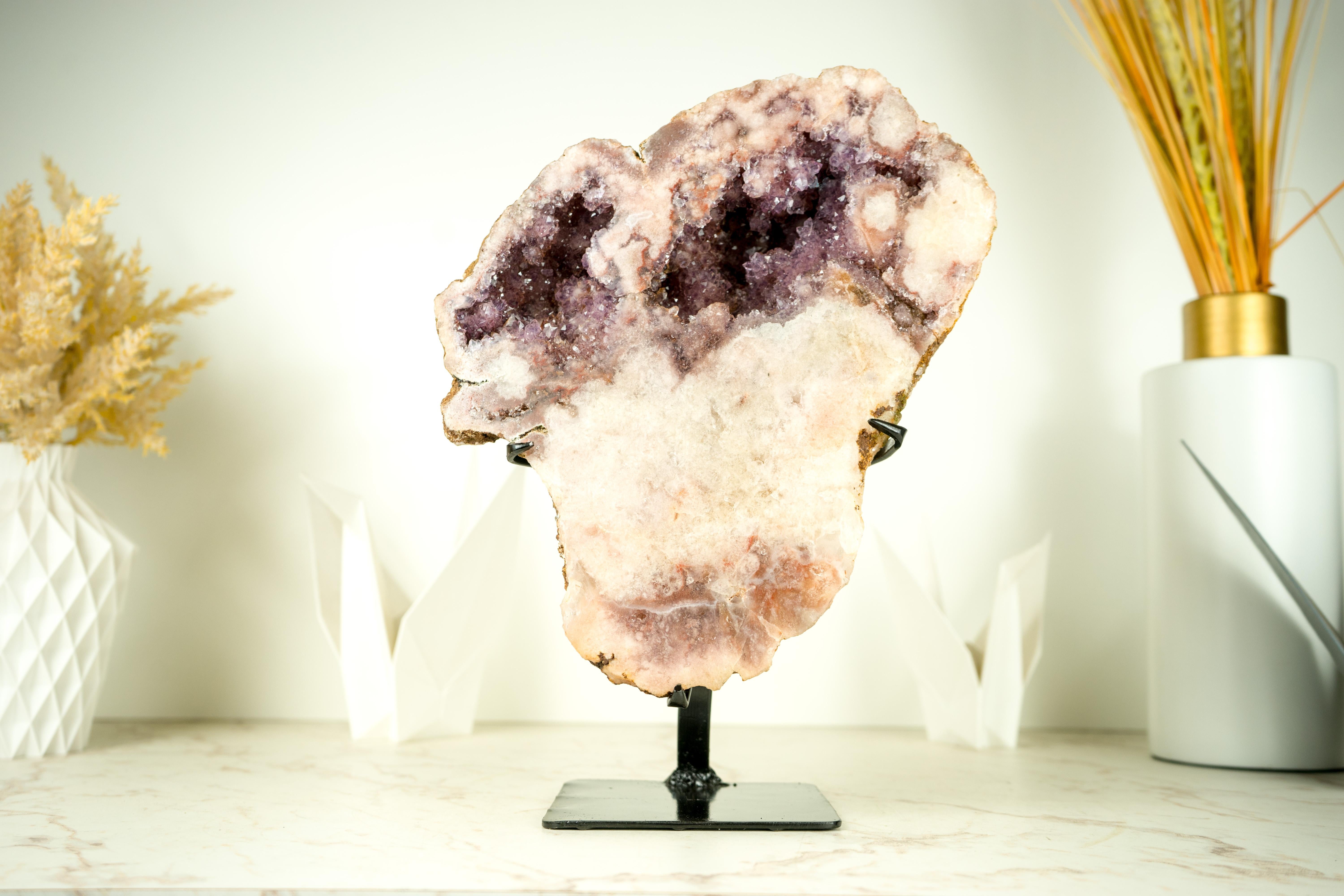 High-Grade Pink Amethyst Geode on Stand with Lavender Pink Amethyst Druzy

▫️ Description

Naturally beautiful, this Pink Amethyst geode exhibits a rare balance of colors, as if it were a painting. The lavender rose druzy contrasts with the pastel