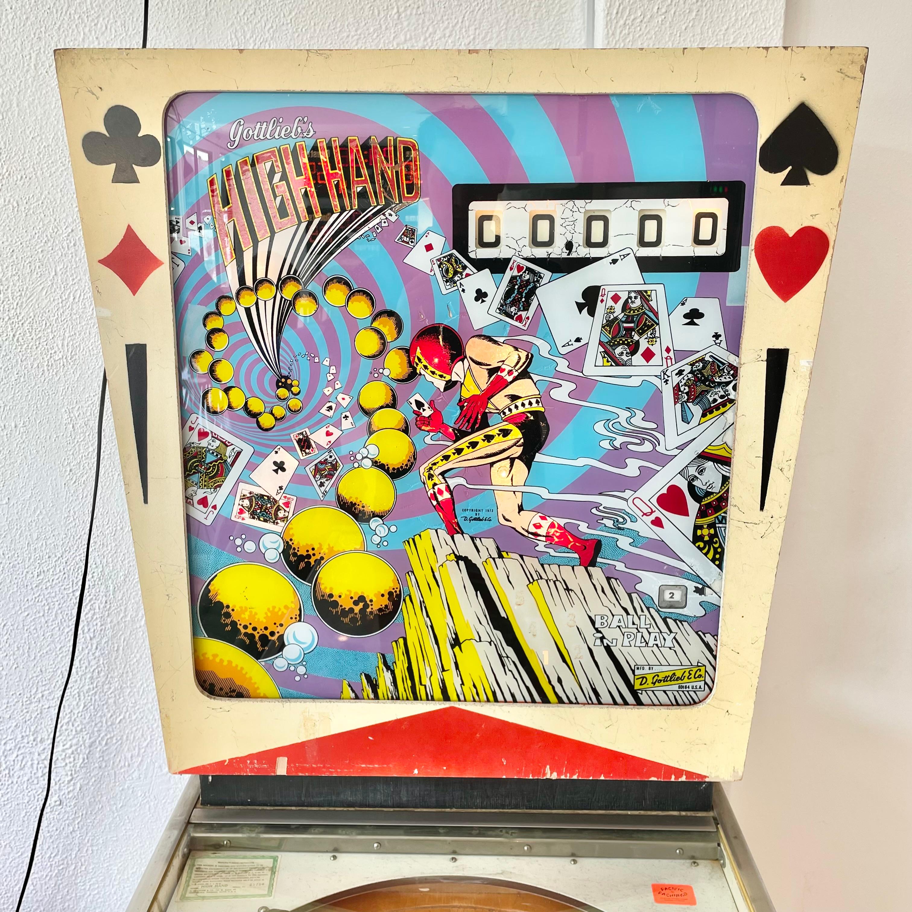 Vintage 'HIGH HAND' pinball machine from 1973. Made by D. Gottlieb & Company and designed by Ed Krynski. In excellent working condition. Great visuals and sounds. Extremely fun paced gameplay. This game features slingshots, drop targets, kick out