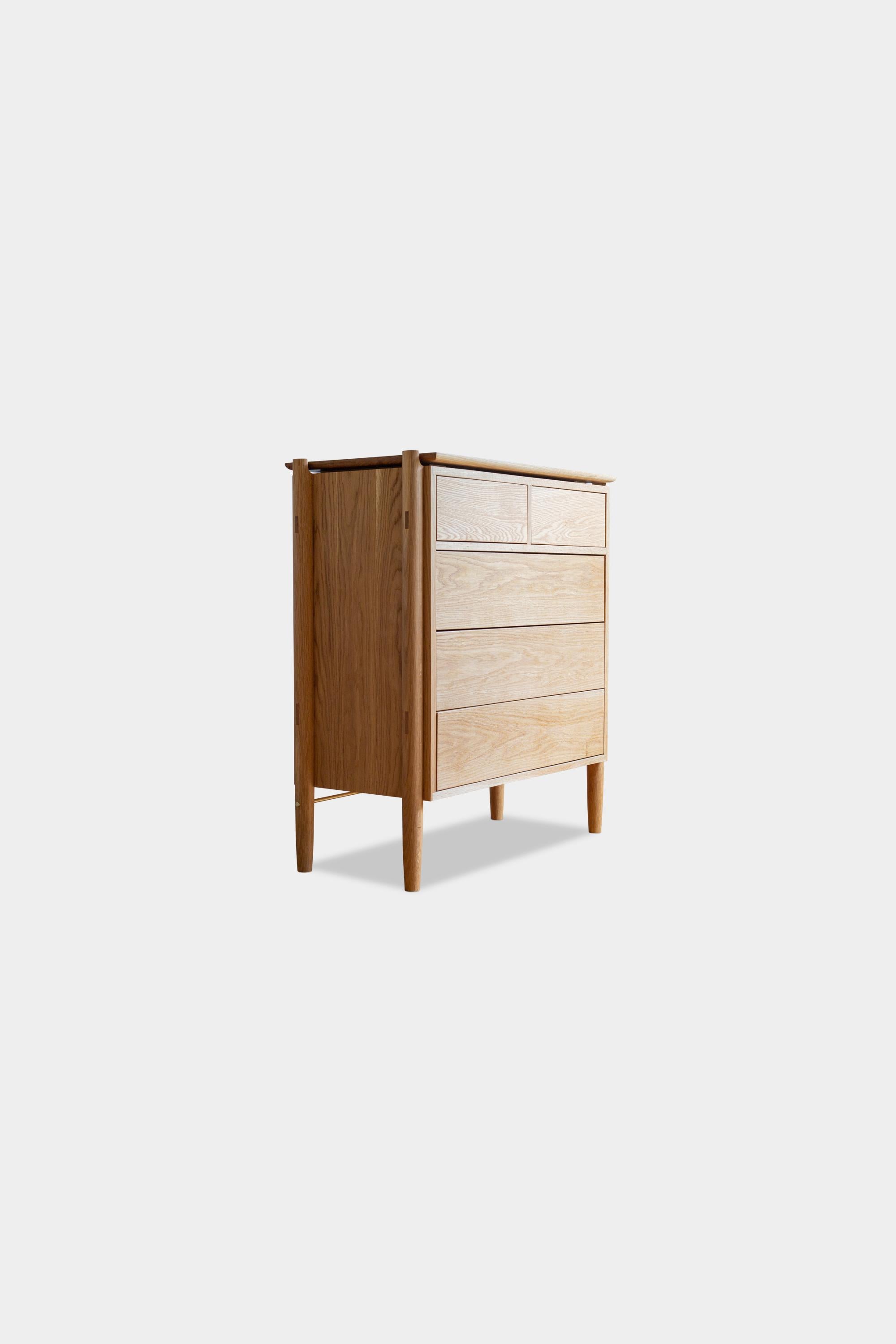 Solid wood constructed sideboard cabinet featuring hand-turned legs, hand-cut joinery and adjustable shelves. It details 5 push-to-open, soft-close drawers. There are custom configurations available, including hand loomed cane cabinet doors, solid