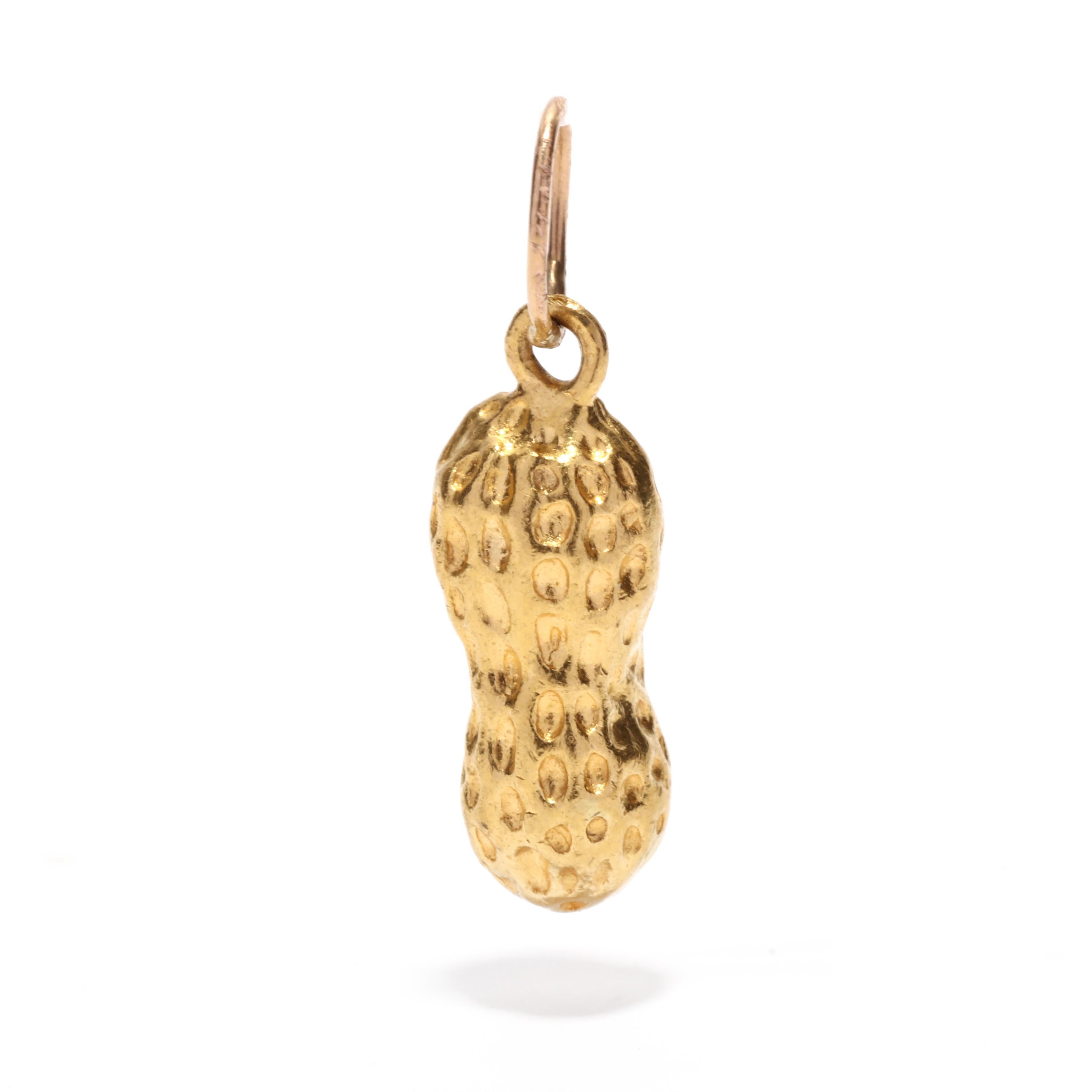A vintage 23 karat yellow gold solid peanut charm. This small charm features a peanut motif suspended from a thin bail.

Length: 7/8 in.

Width: 1/4 in.

Weight: 1/3 dwts. / 2 grams

Metal: 23K (tested)

Ring Sizings & Modifications:
* We are happy