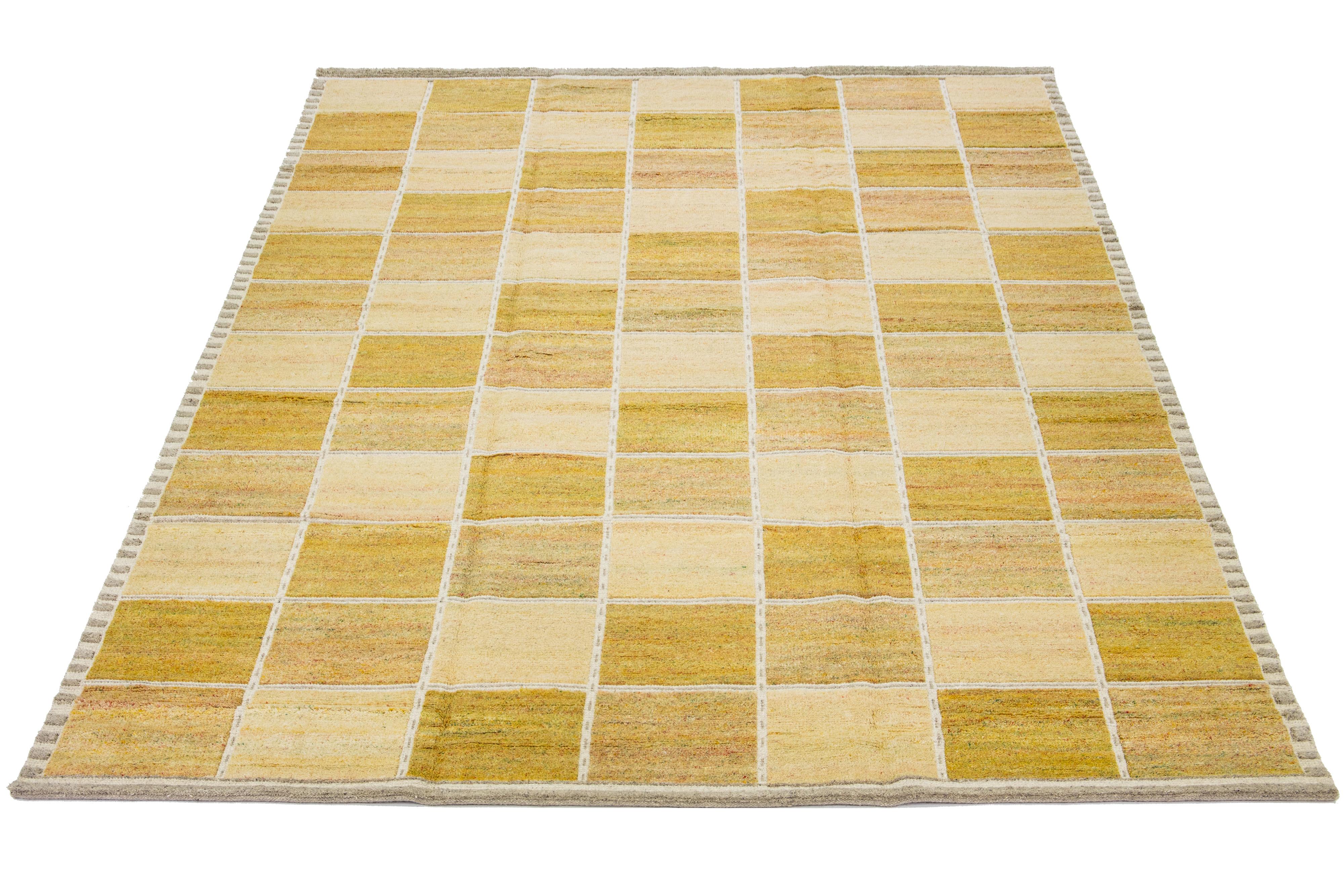 This flatweave rug showcases a contemporary Swedish design with a yellow and beige background, complemented by accents of ivory and green. Geometric patterns are featured throughout the entire design.

 This rug measures 9'10