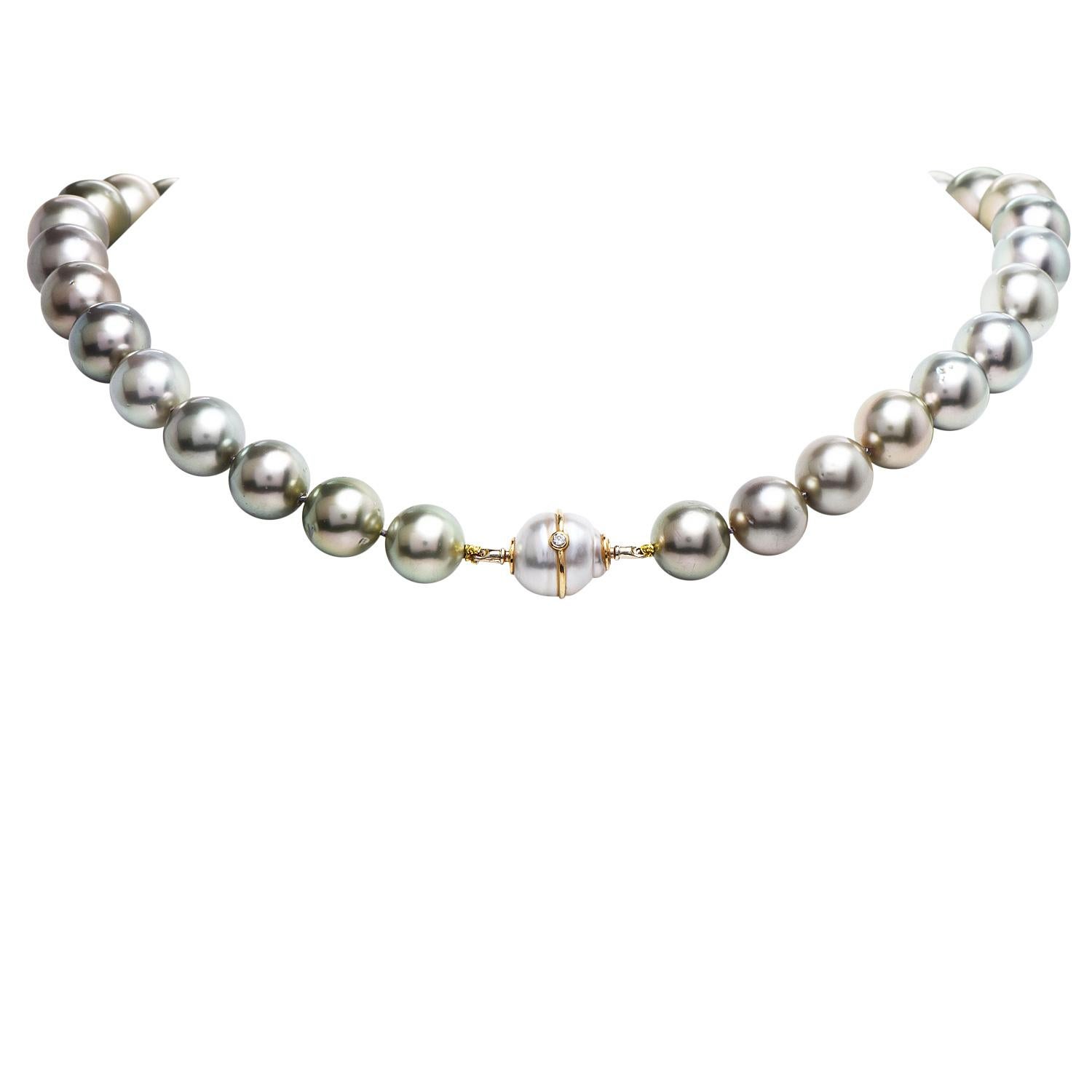 This Tahitian South Sea Pearl Diamond 18k  pearl and Gold displays 33 of lustrous graduated South Sea Pearls with Peacock gray tone. They measure 14mm to 10.5mm in diameter, perfectly matching in color and size.

The necklace weighs 84.5 grams and