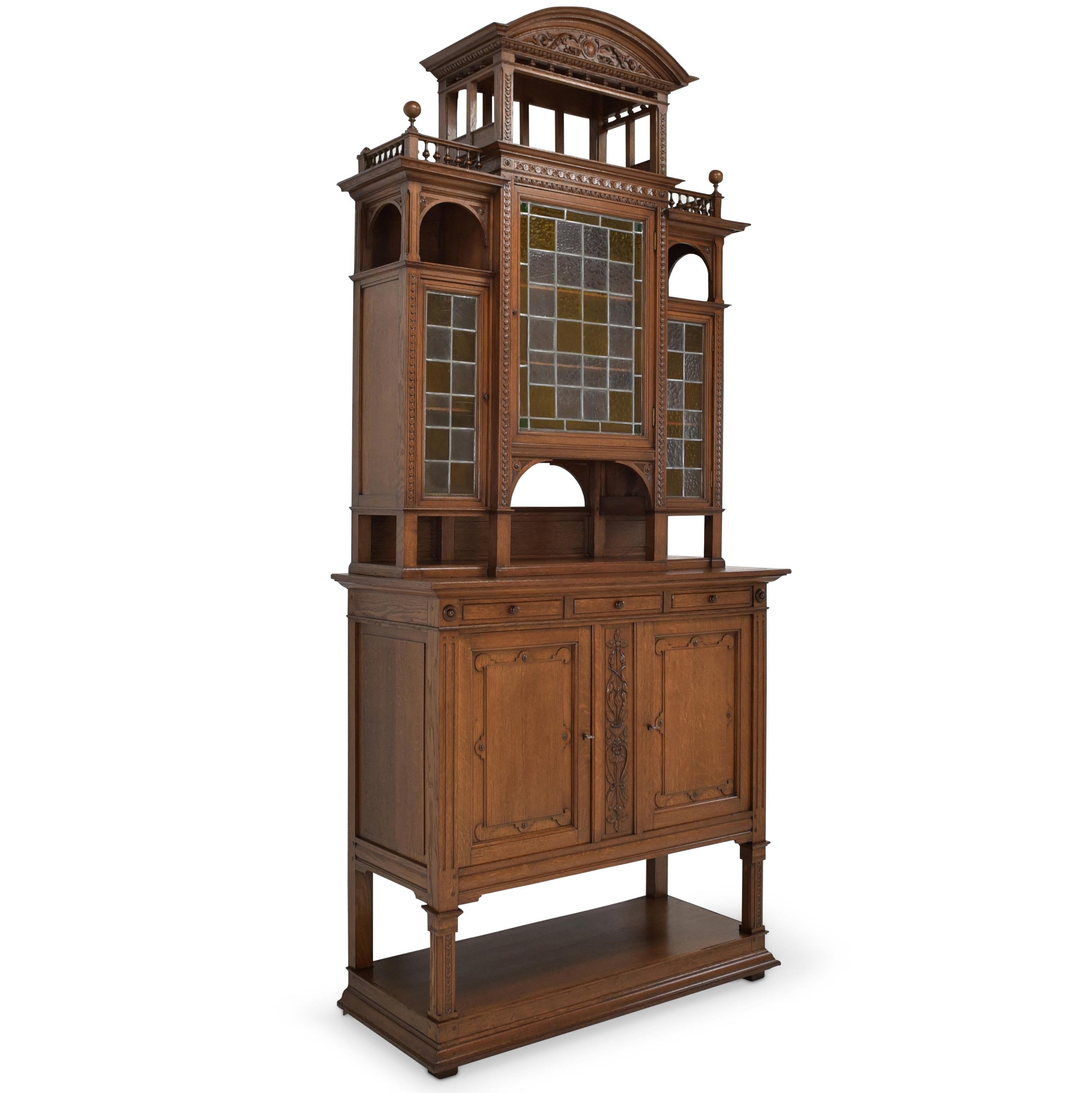 Buffet cabinet restored high & narrow Gründerzeit around 1900 solid oak

Features:
Tiered, three-door top with open compartments
Two-door base with one drawer and open compartment below
Very high quality processing
Drawer pronged
Cassette