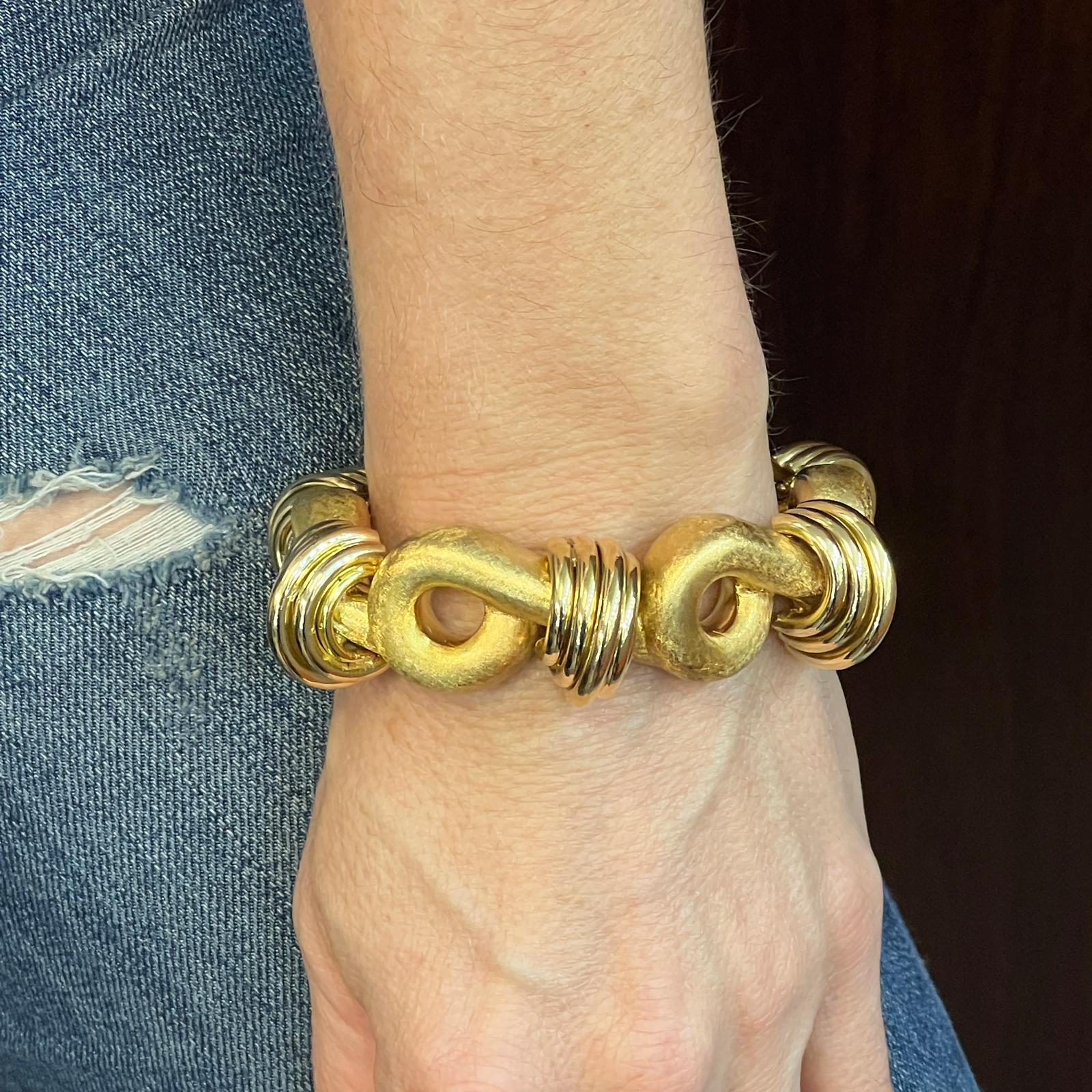 Fabulous heavy gold bracelet handcrafted in 18 karat yellow gold. The bracelet features satin finish and high polish ribbed sections. The bracelet measures 8.25 inches in length and 20mm in width. 