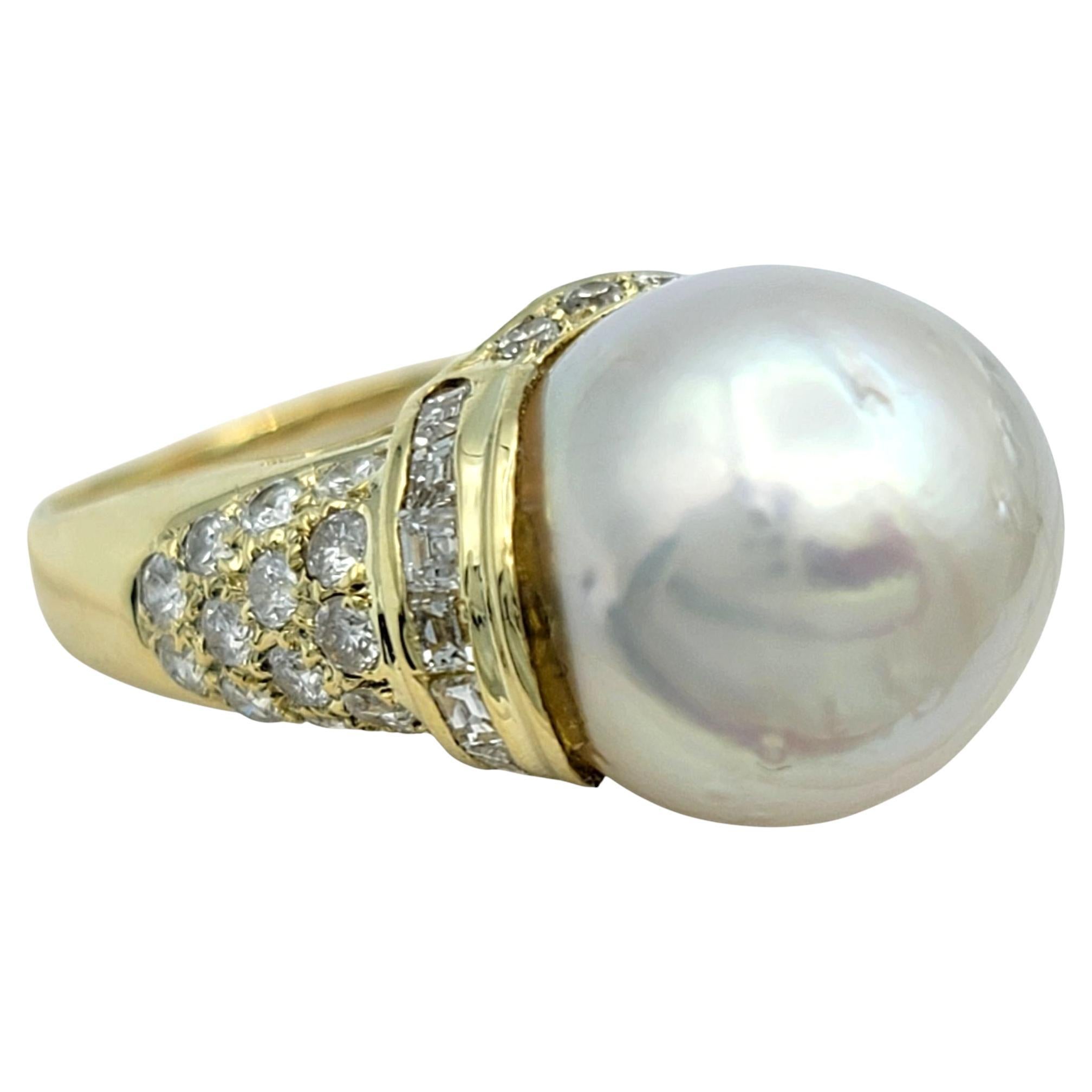 Ring Size: 7

This high-set ring showcases a large white pearl that sits prominently above the band, drawing focus with its smooth surface and luminous sheen. The pearl is surrounded by a dramatic, structured frame of pavé diamonds that rise up and
