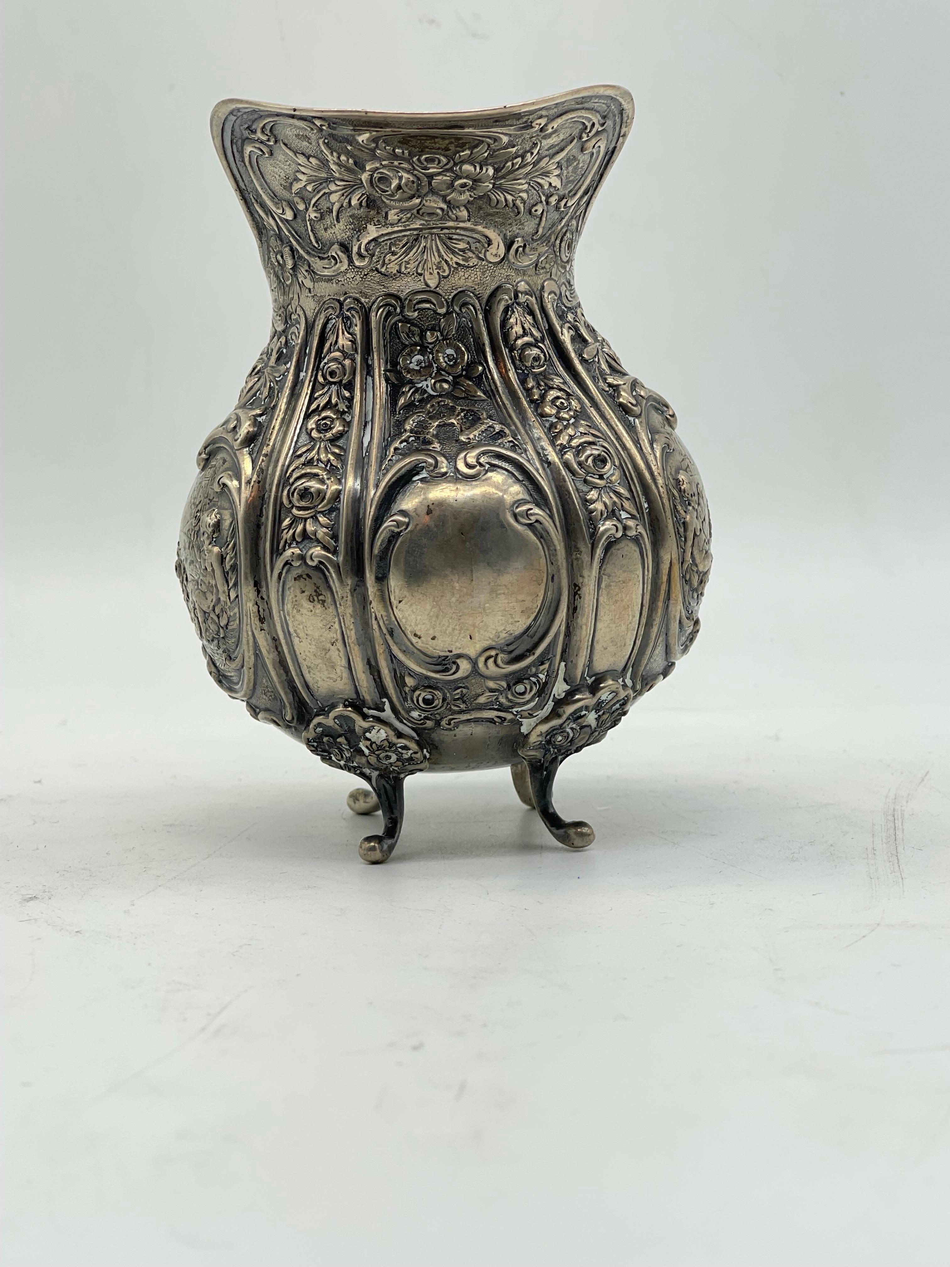High-Quality beautiful Silver Milk Jug

Flowers & Children ornament
stand on 4 feet

800 Silver - probably from Germany

Weight: 302 grams

The condition can be seen in the pictures.