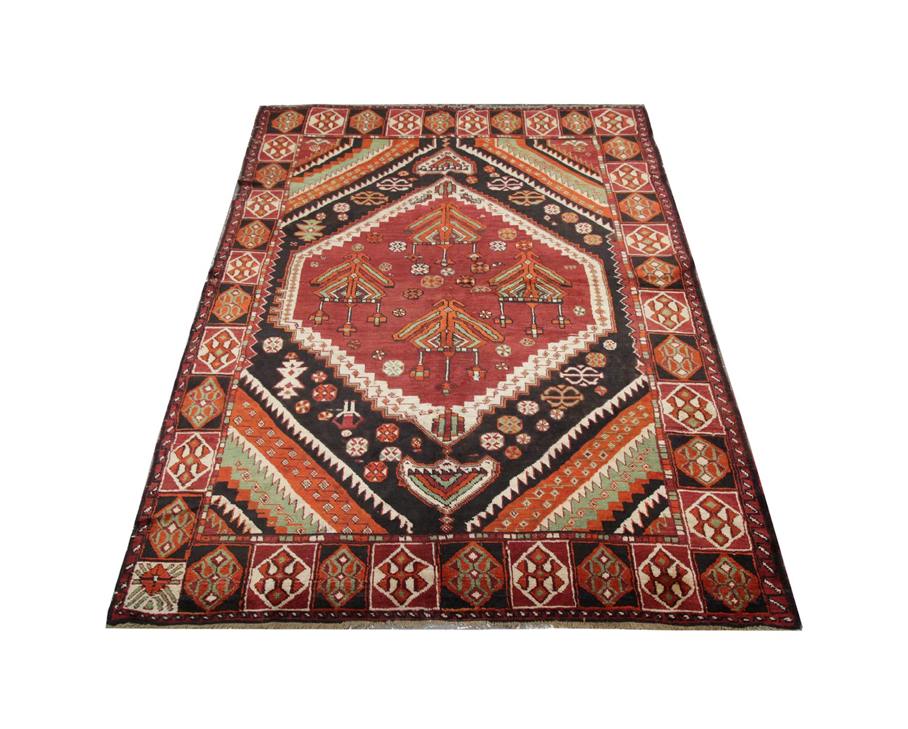 Rich, bold reds and oranges elevate the design in this high-quality antique Azerbaijan rug was handwoven in 1920 with hand-spun, vegetable-dyed wool, and cotton, by some of the finest Caucasian artisans. Perfect for both modern or traditional