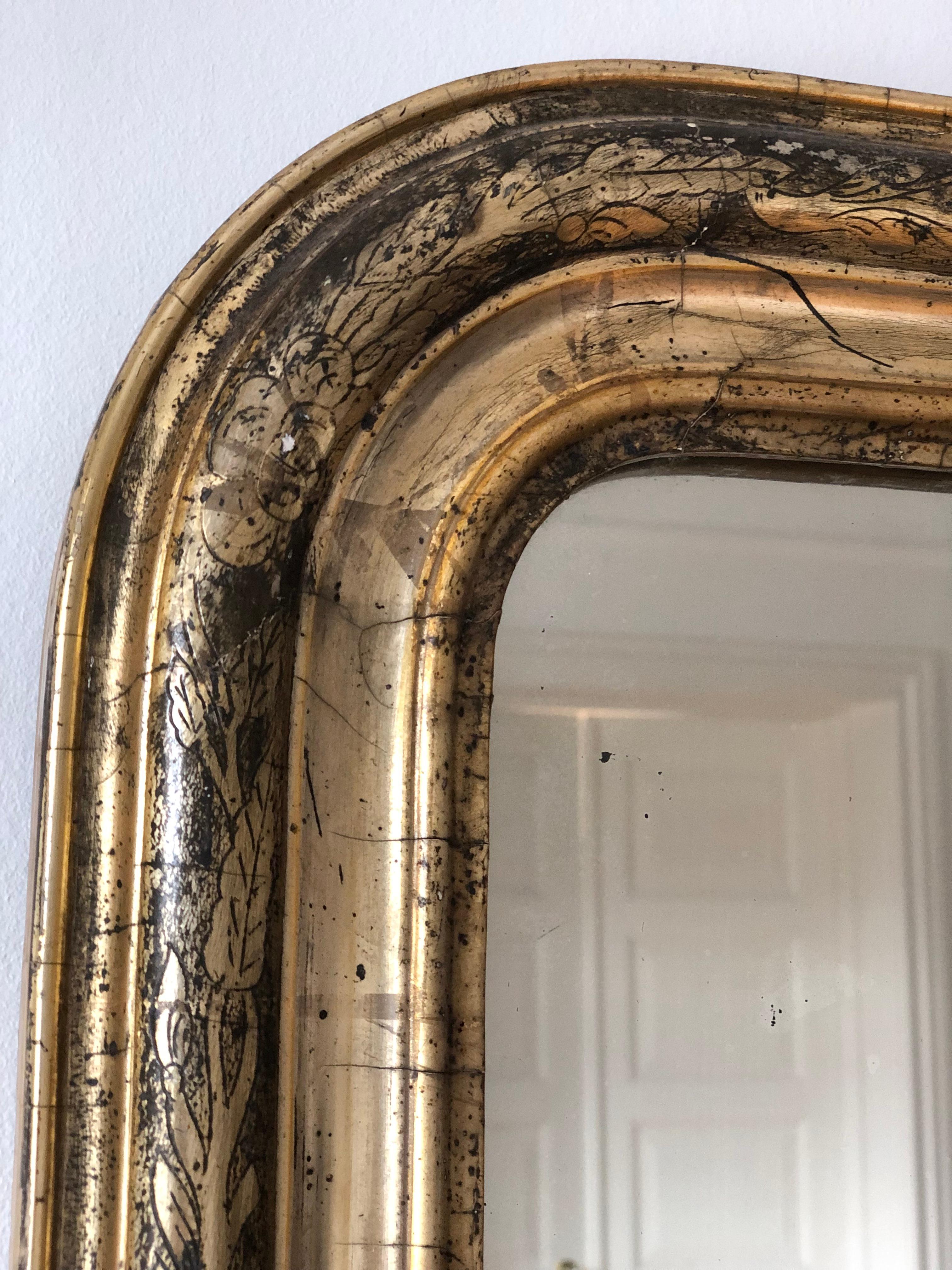 A very high-quality antique Louis Philippe mirror from France, dating to the late 19th century.
With an appearance of grandeur, the carved giltwood frame features gracefully curved top corners and a beautiful worn gold leaf patina. 

Object: