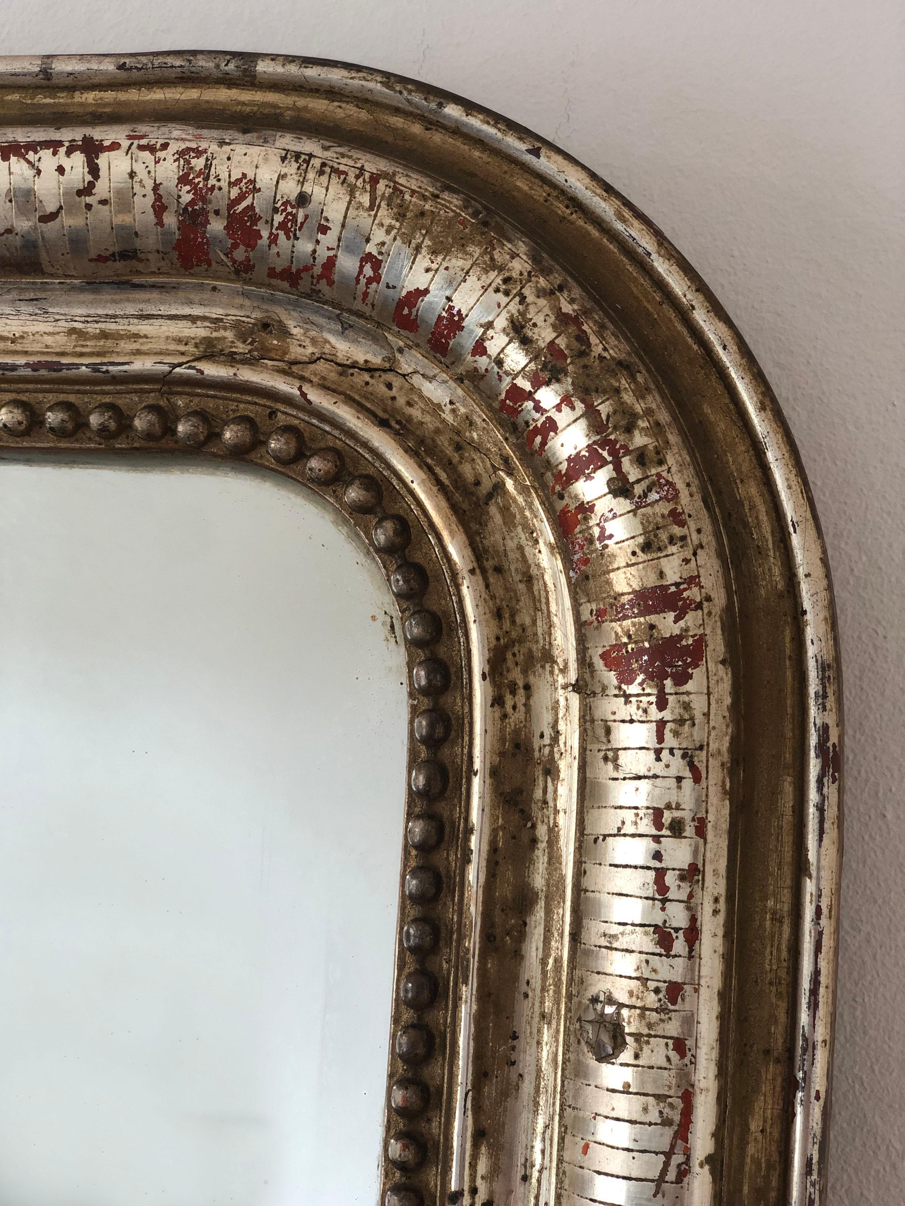 Espejo Louis Philippe antiguo de gran calidad procedente de Francia, de finales del siglo XIX.
Con una apariencia de grandeza, el marco de madera dorada / oro blanco ricamente tallado presenta esquinas superiores graciosamente curvadas, una hermosa