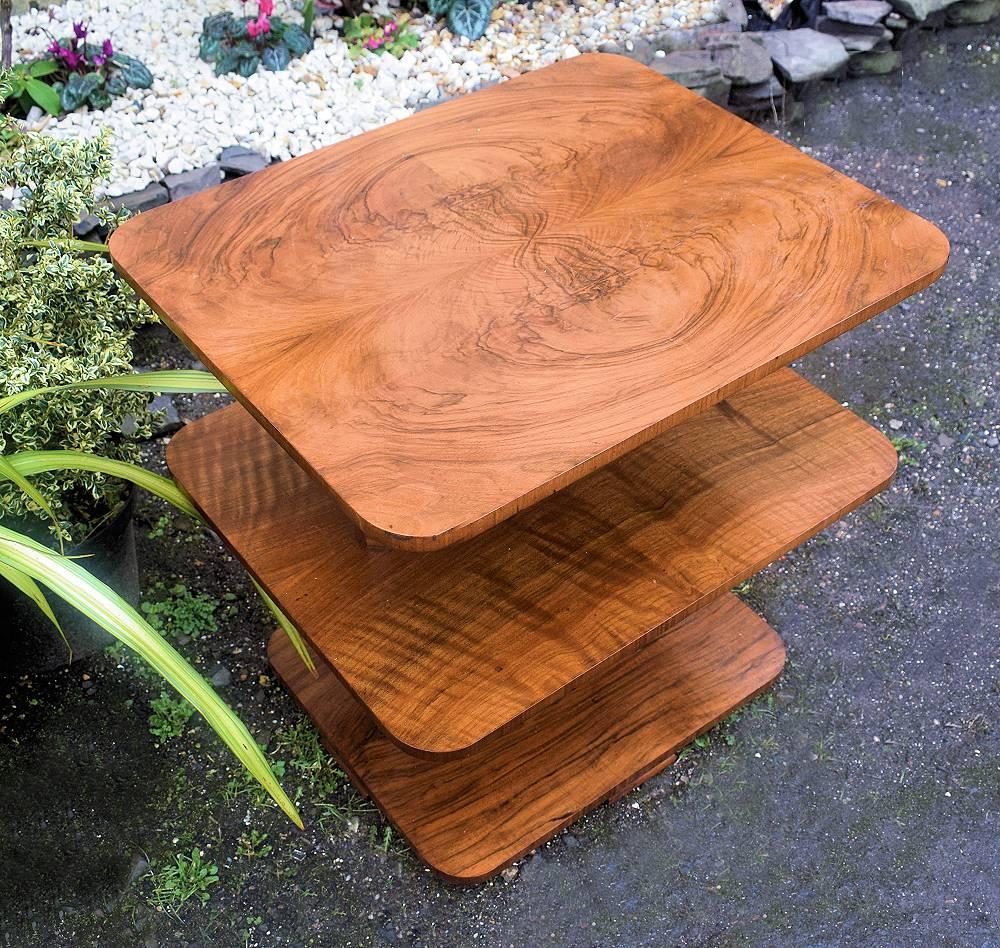 Very stylish Art Deco English modernist table dating to the 1930s. A very fine example that can be used for multiple purposes, a centre, end, coffee table. Fabulous quality with figured walnut veneers throughout. Three-tiered making this an ideal